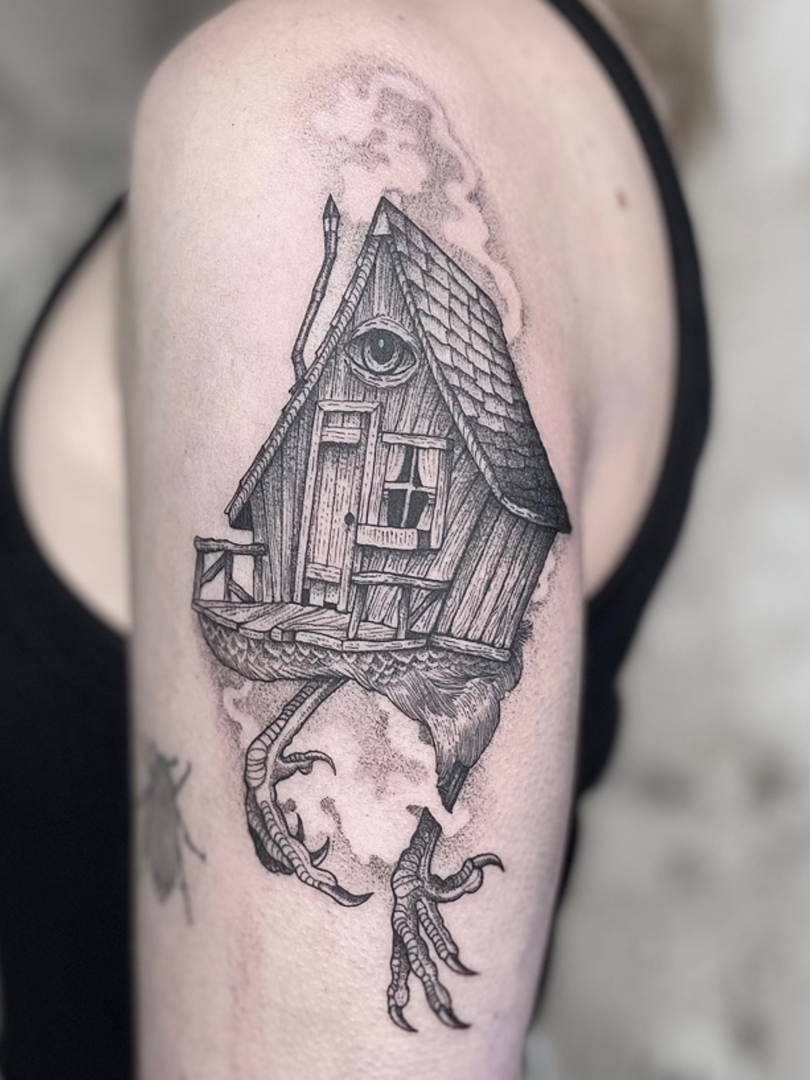 Tattoo of a chicken with a house on its back and smoke coming out of the chimney on the person's arm.
