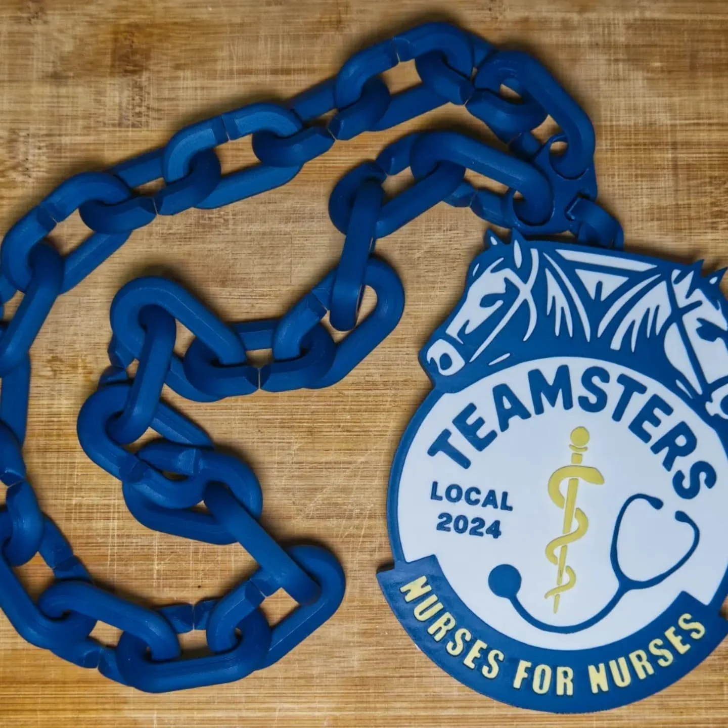 Show your solidarity and union pride with a custom-designed 'Nurses for Nurses' swag pendant! Made specifically for the dedicated members of Teamsters Local 2024, this pendant is a bold statement of unity and strength.

Each pendant includes a genero