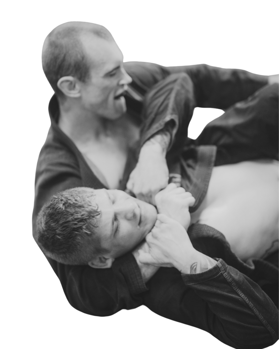 Two men engaged in Brazilian Jiu-Jitsu grappling match, one pinning the other on the ground.