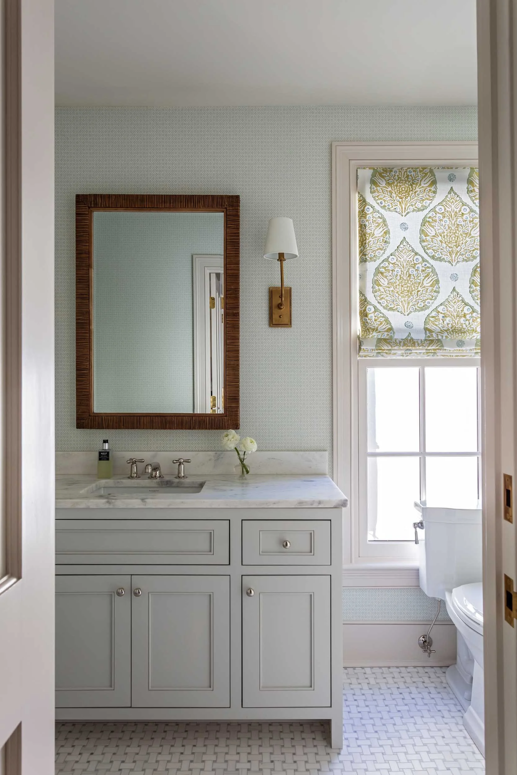 guest-bathroom-roman-shade-basketweave-tile-floor-schumacher-diamond-wallpaper.jpg
