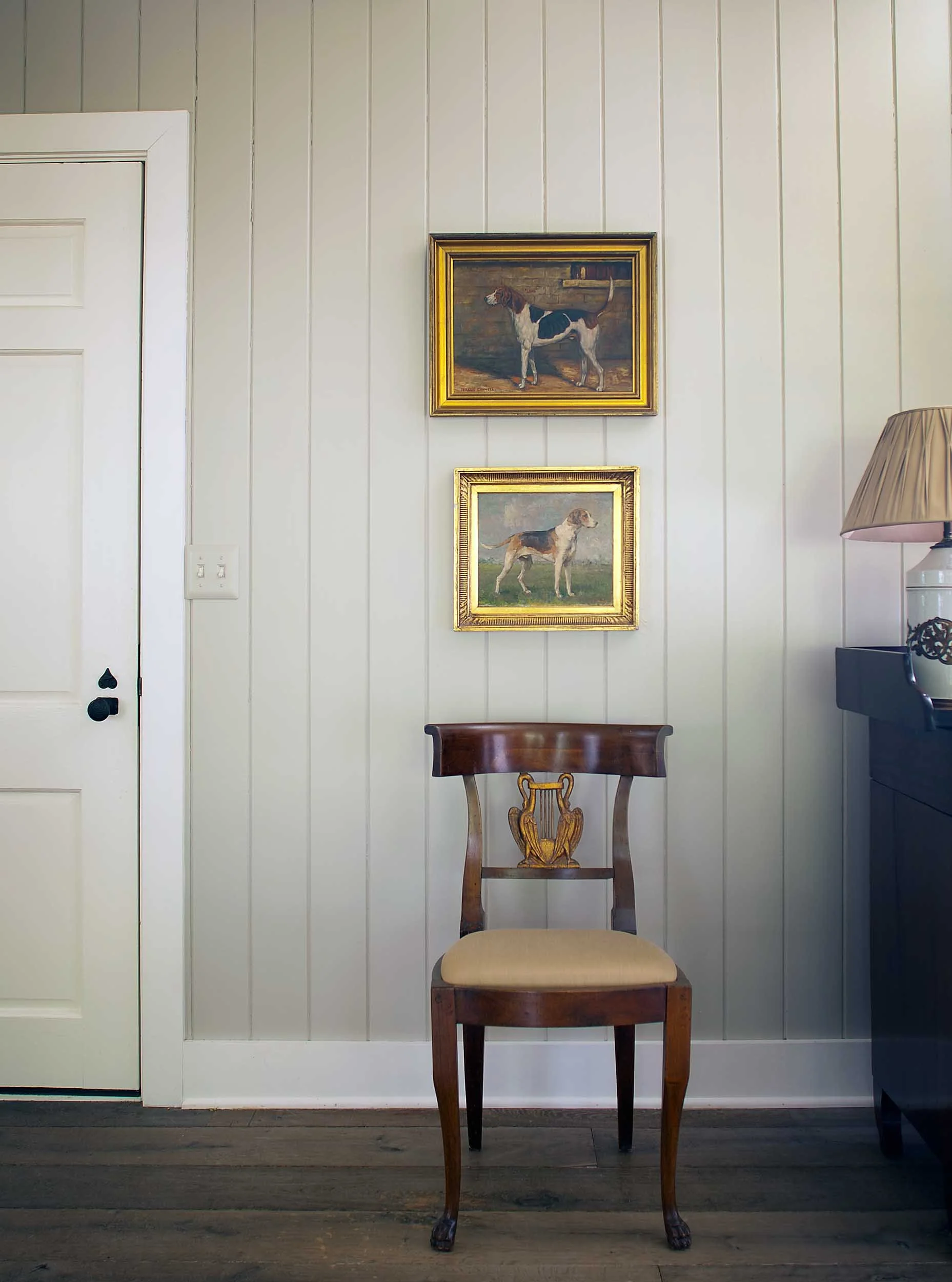 wood-paneled-hall-with-vintage-dog-paintings.jpg