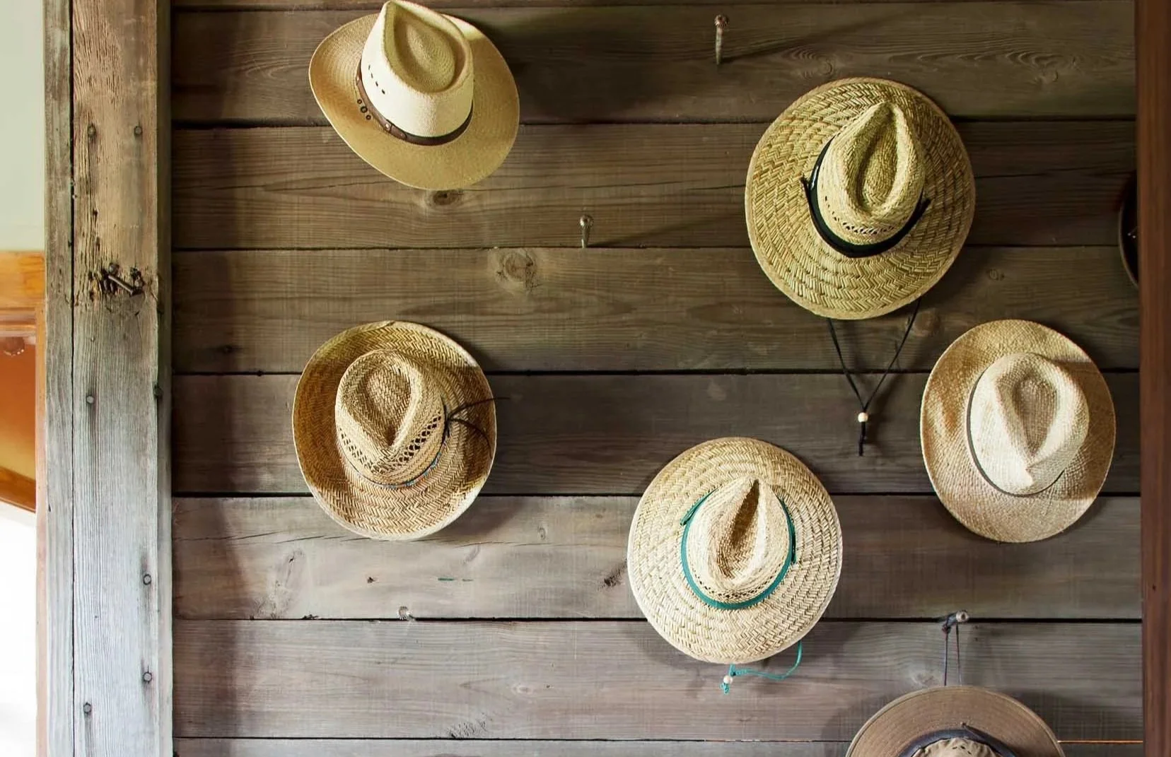 hats-hanging-on-weathered-wood-wall-closet.jpg
