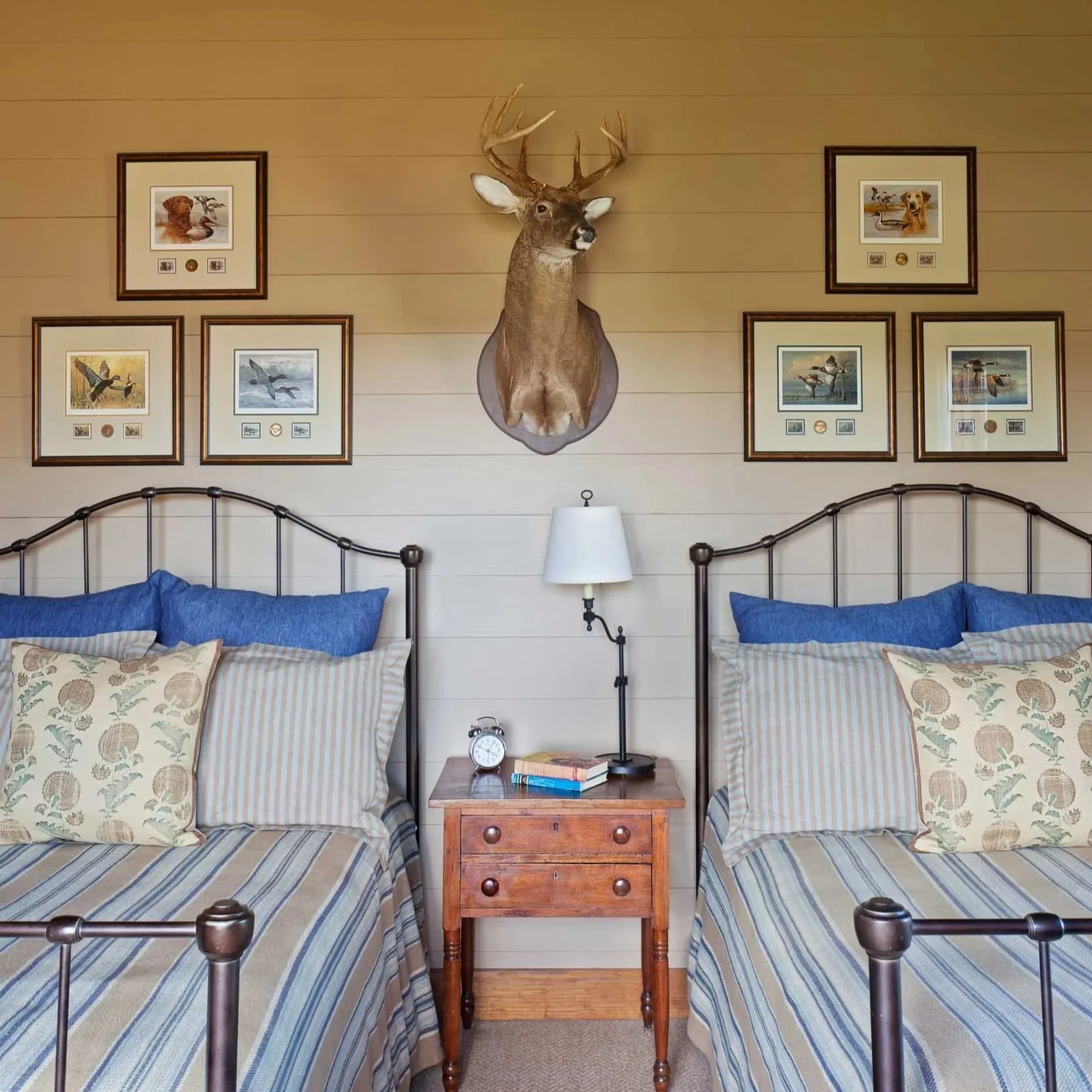 guest-bedroom-with-two-twin-metal-frame-beds-stuffed-deer-head-vintage-art.jpg