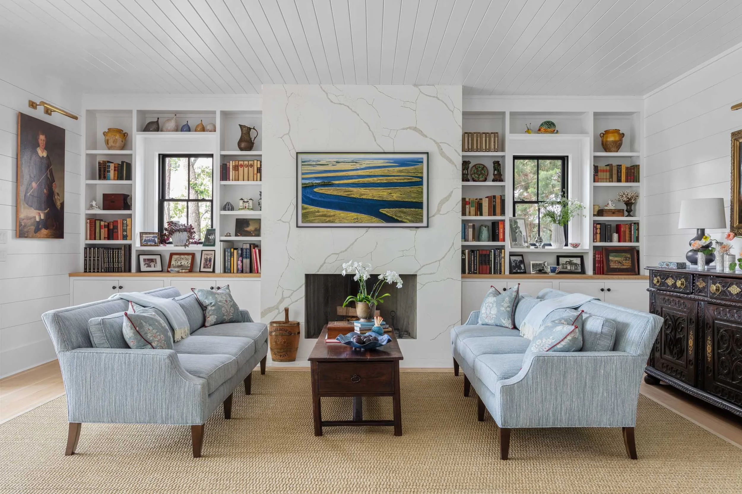 edward-farrell-blue-linen-sofas-sisal-rug-antique-coffee-table-shiplap-ceiling-butted-board-walls.jpg