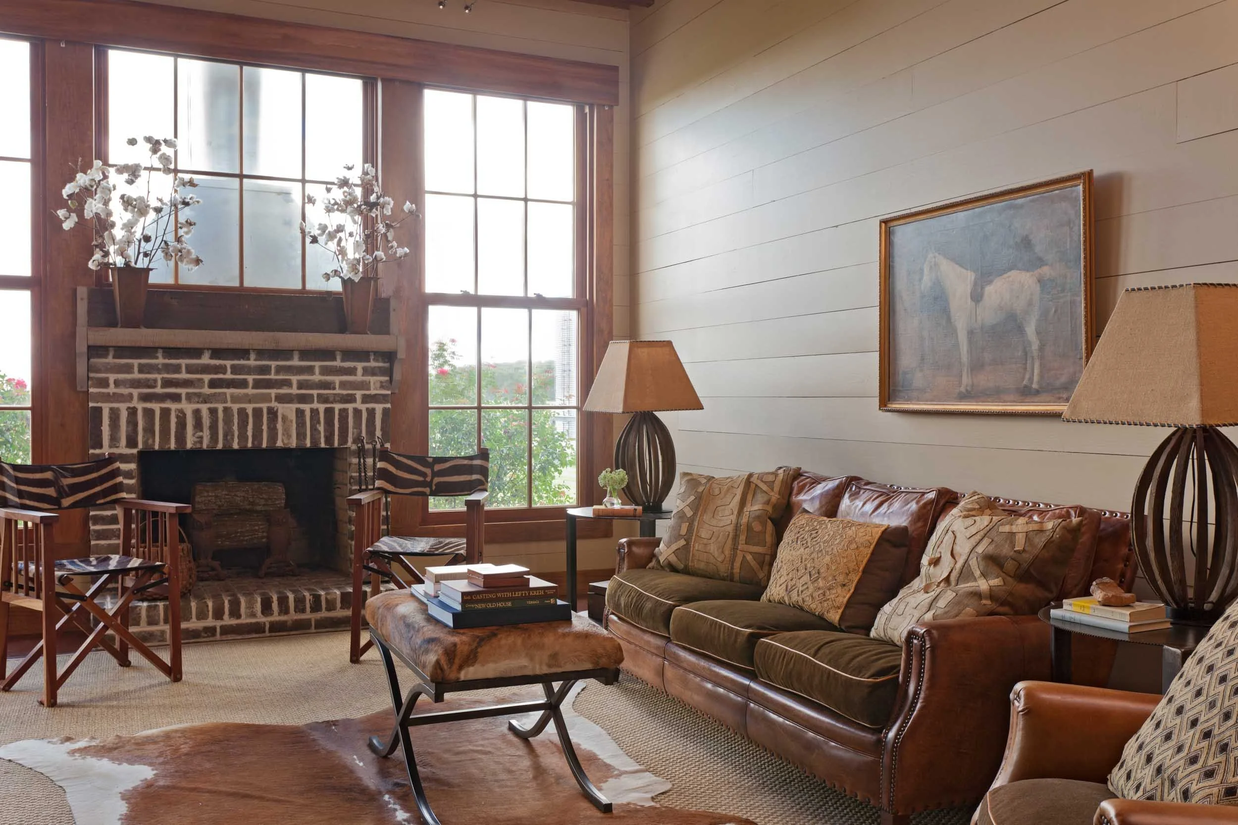 wood-paneled-den-with-largh-windows-leather-couch-horse-oil-painting.jpg