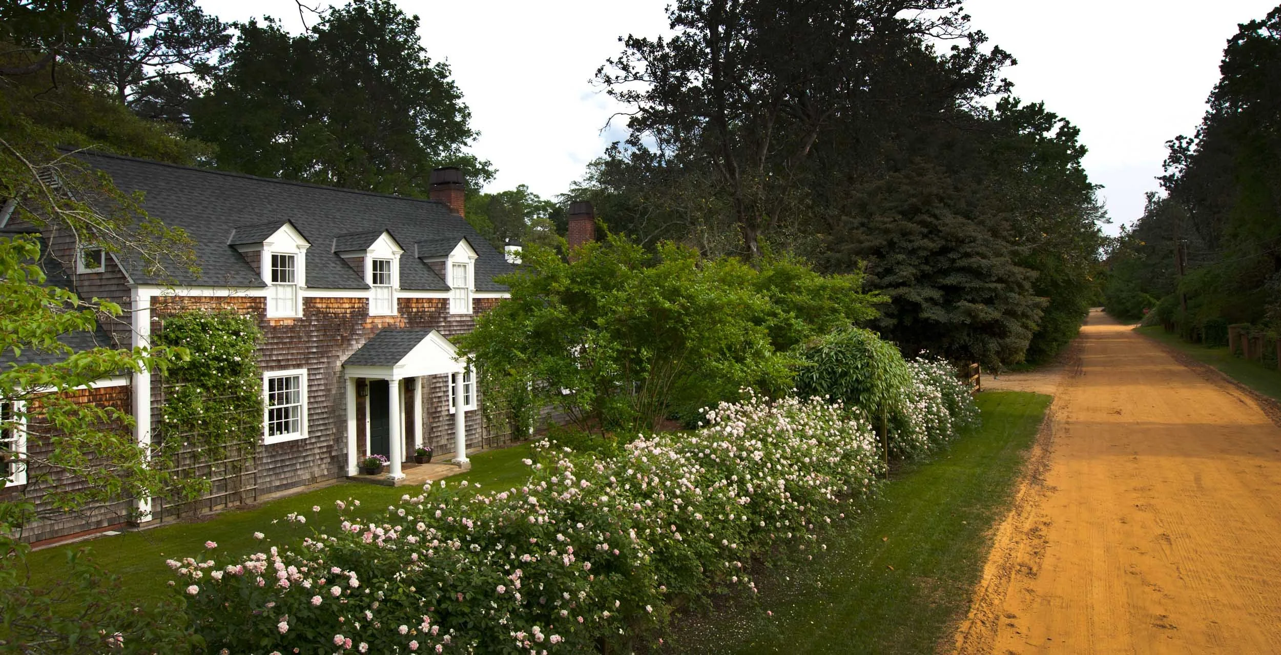 inviting-country-getaway-with-lush-pink-rose-hedge.jpg