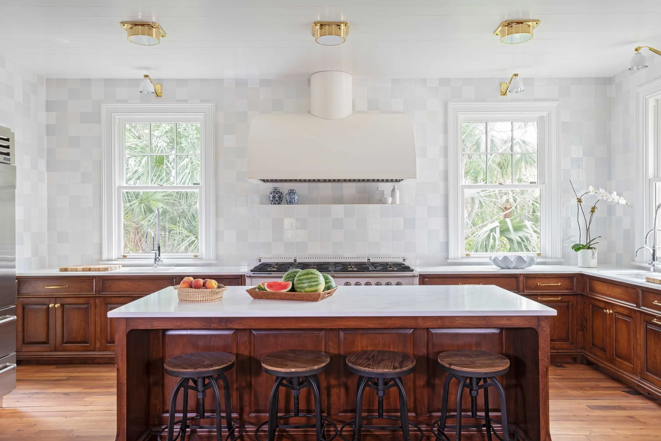 kitchen-white-namib-marble-countertops-delft-mosiac-tile backsplash-vintage-barstools.jpg