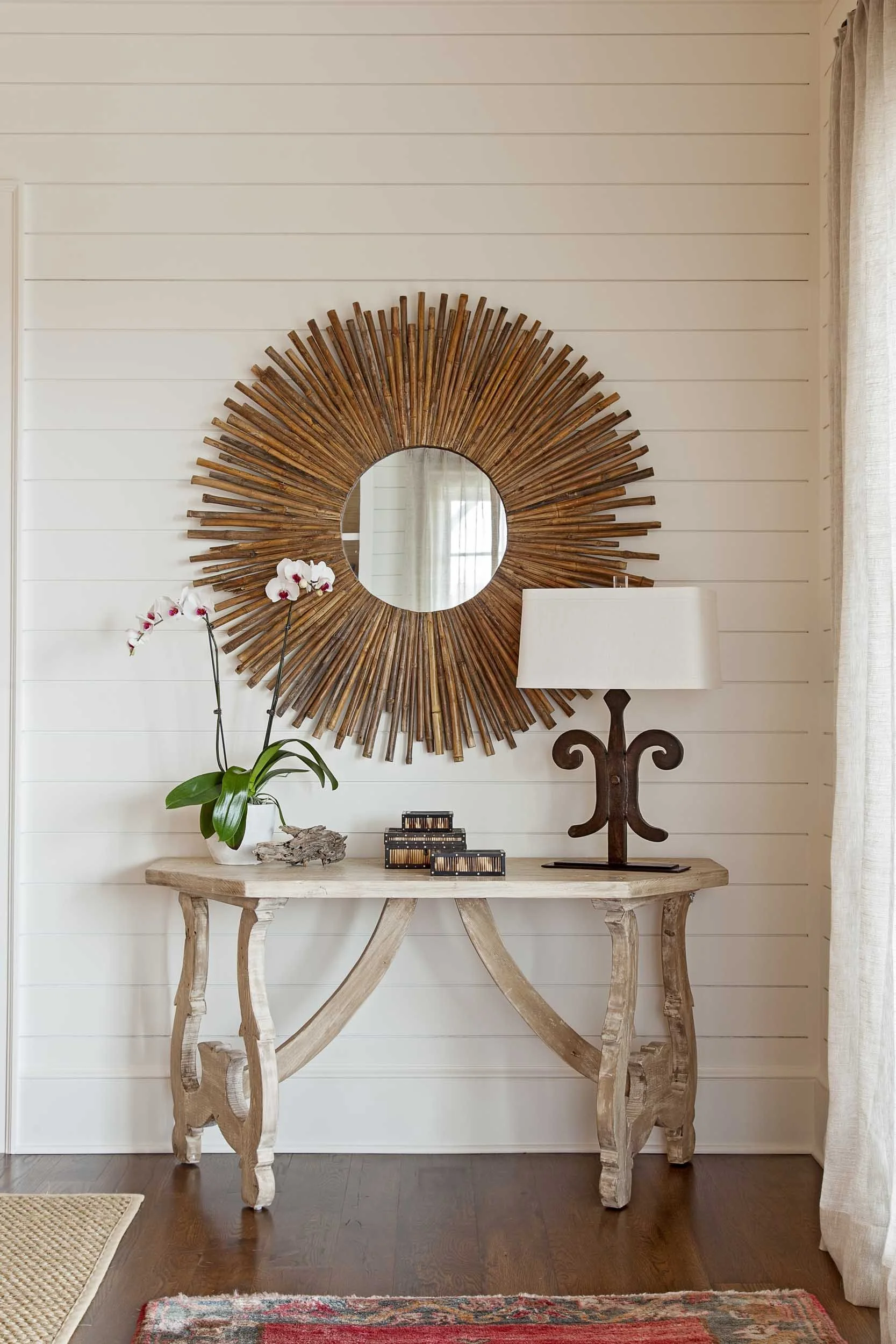 wood-paneled-entry-with-consol-table-and-sunburst-mirror.jpg