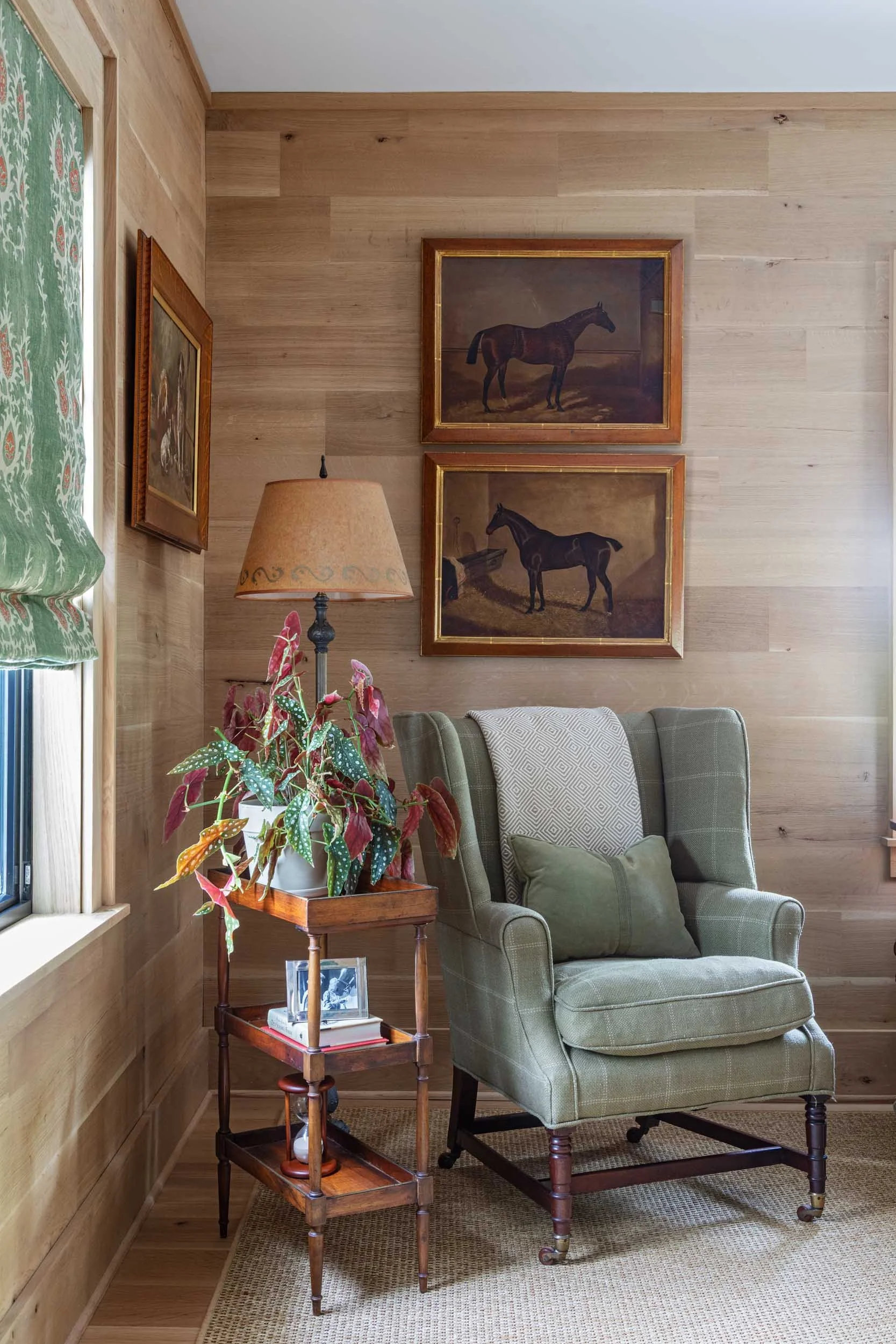 upstairs-study-restored-antique-wingback-chair-petite-butlers-trolley-green-roman-shade-wood-paneling.jpg