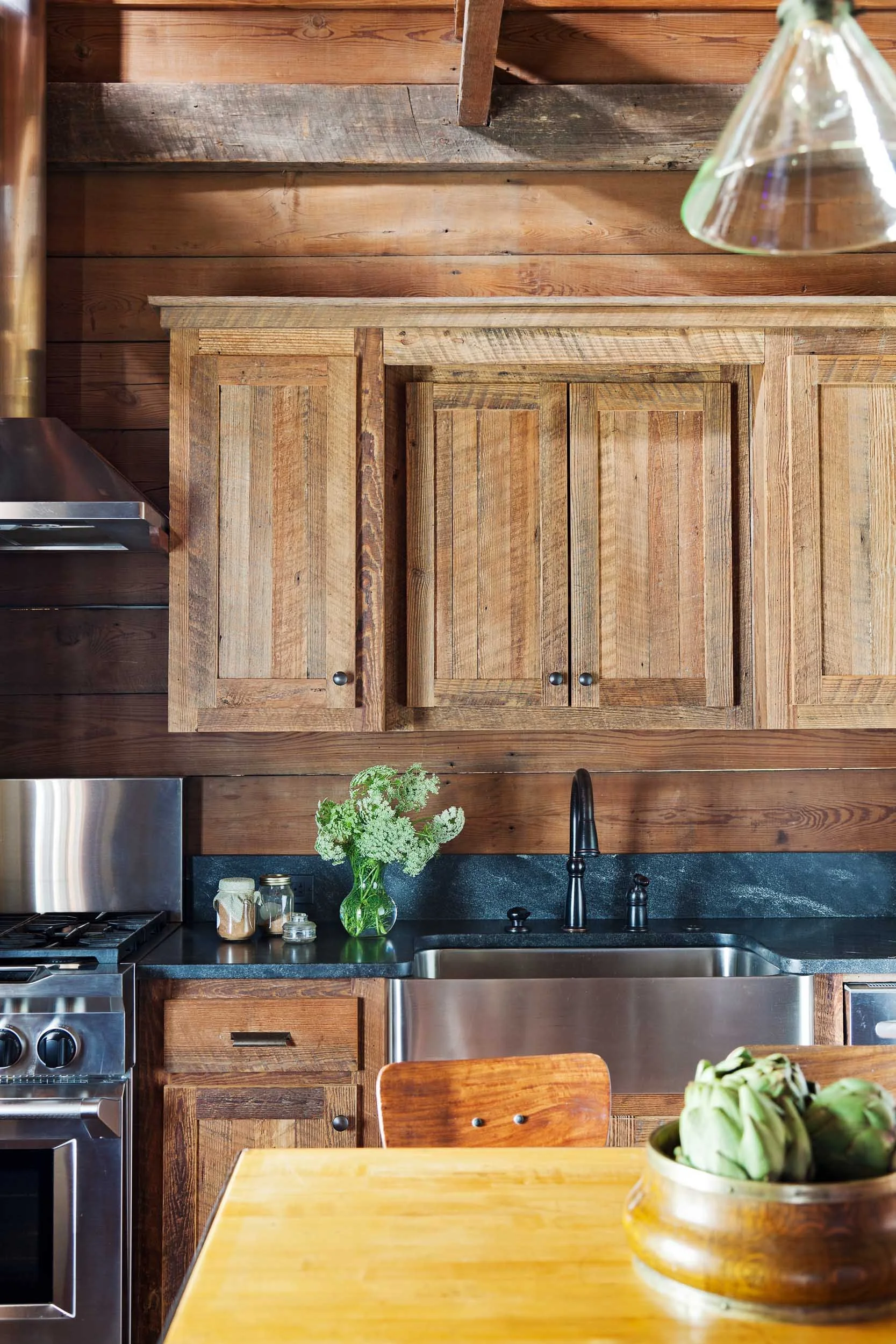kitchen-with-rustic-wood-cabinetry-slate-countertops-stainless-steel-fixtures.jpg