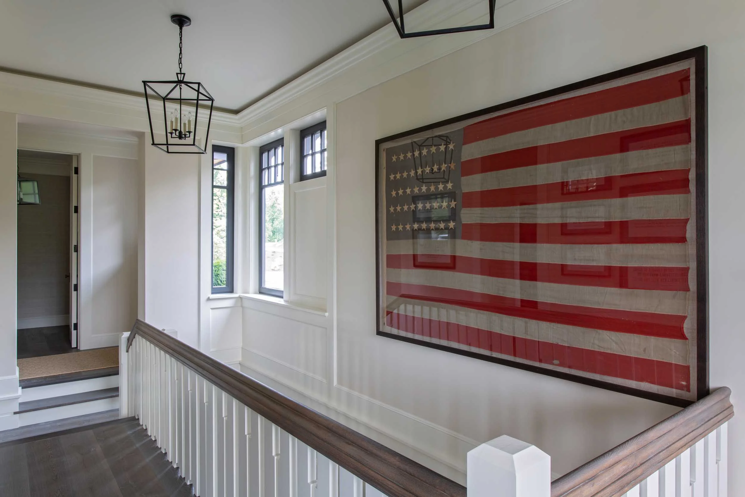 vintage-42-star-american-flag-graces-top-of-lake-house-stairs.jpg