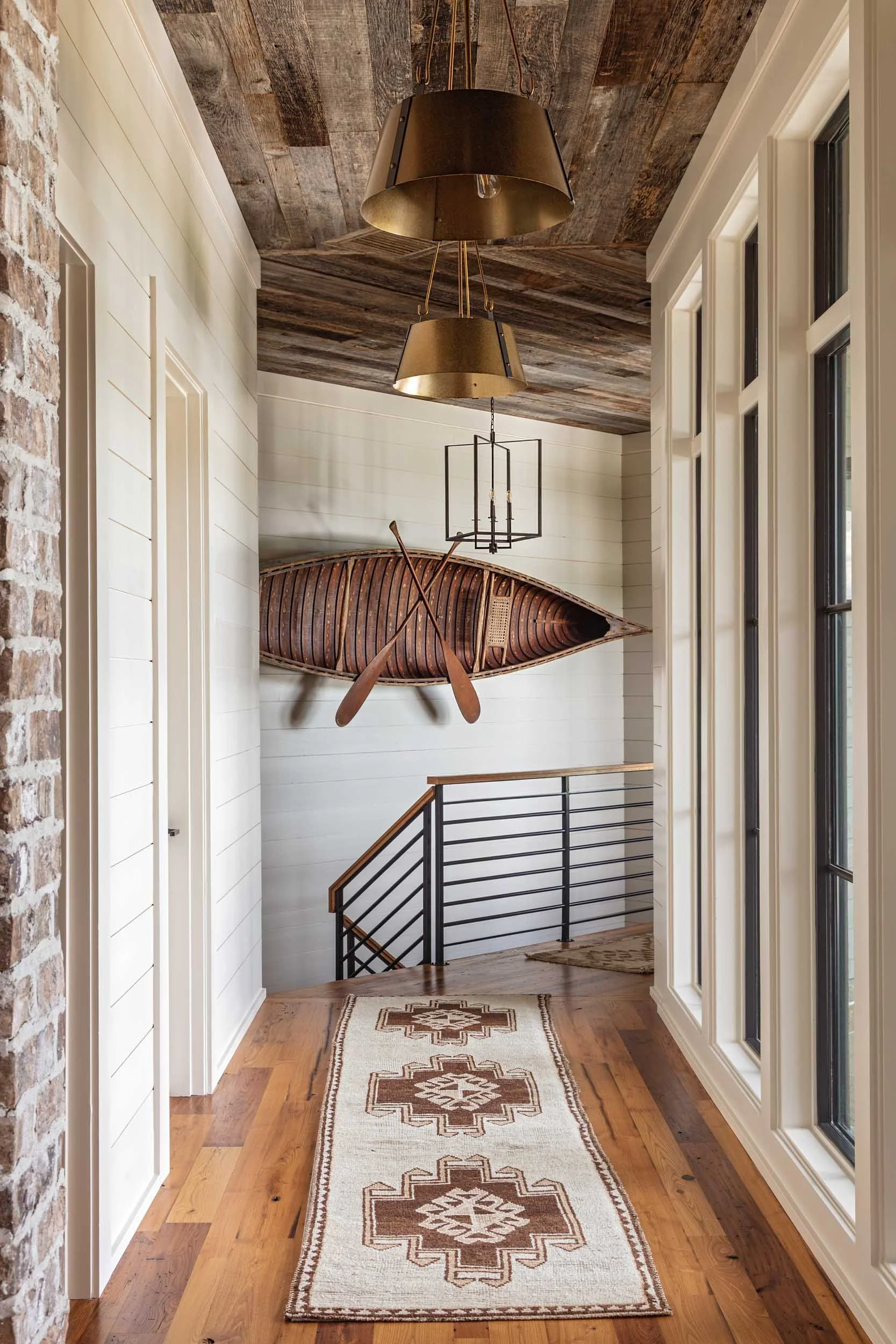 vintage-canoe-hangs-above-hallway-tribal-pattern-vintage-runner.jpg