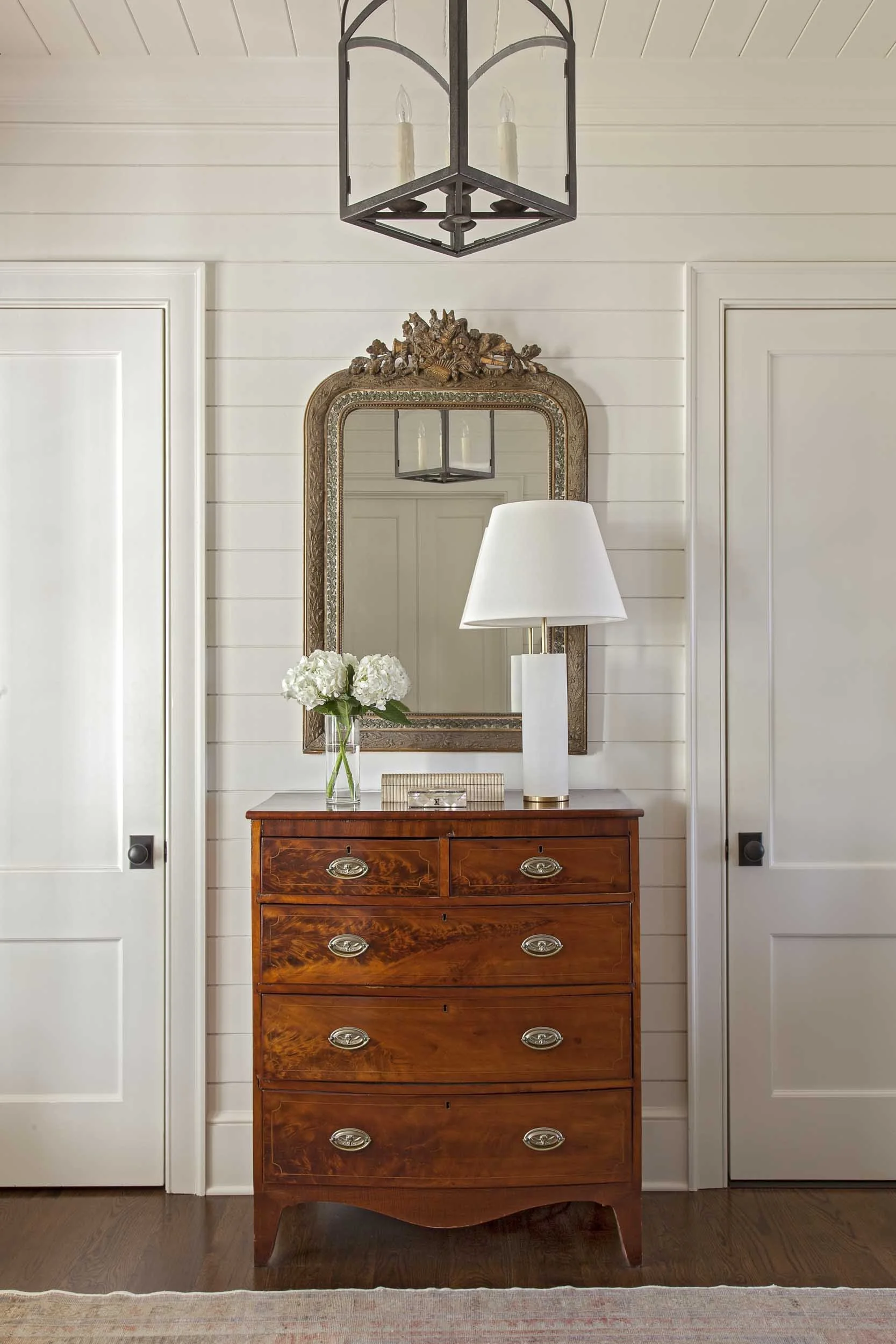 wood-paneled-hall-with-antique-chest-and-brass-mirror.jpg