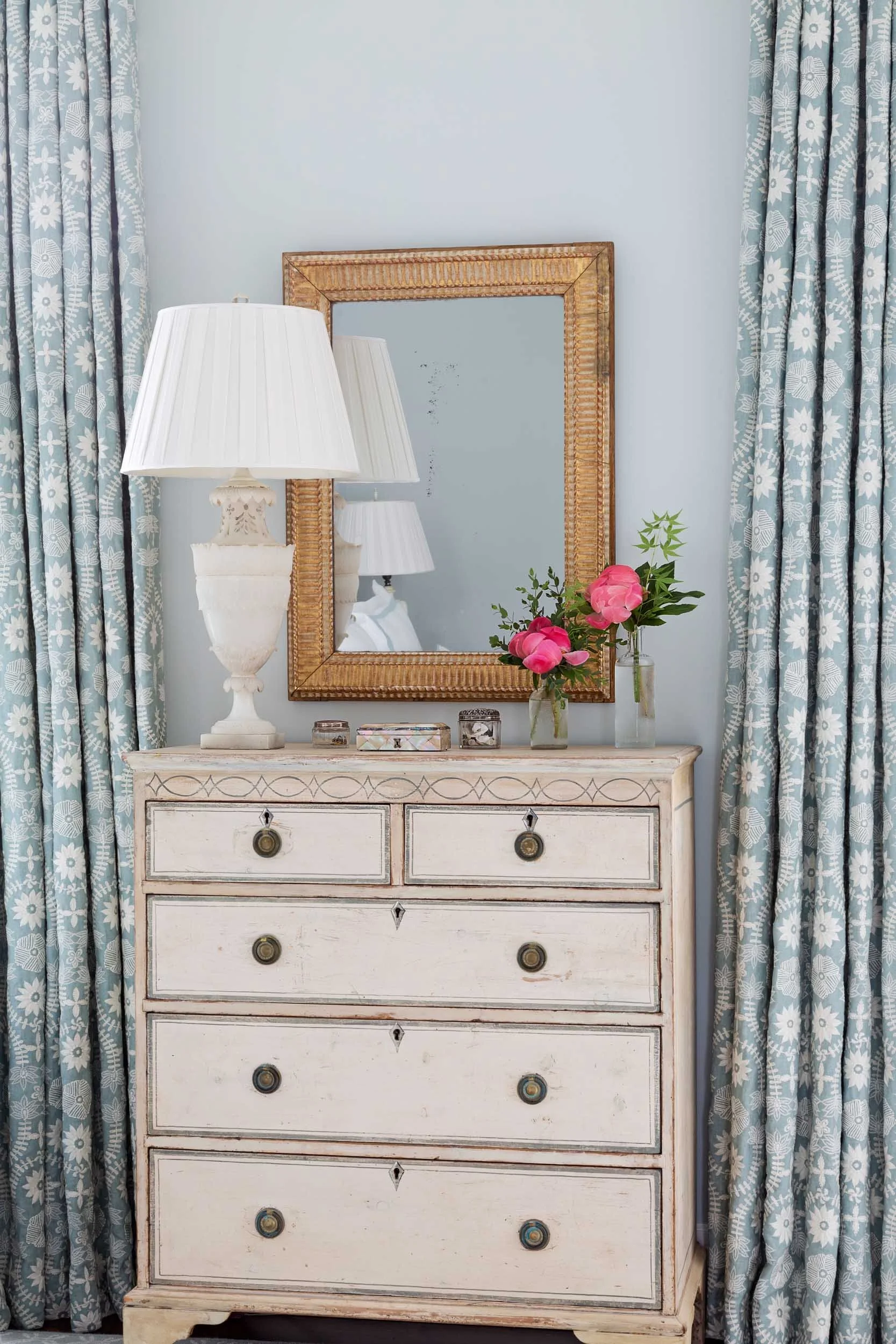 embroidered-linen-curtains-flank-an-antique-painted-chest-of-drawers.jpg