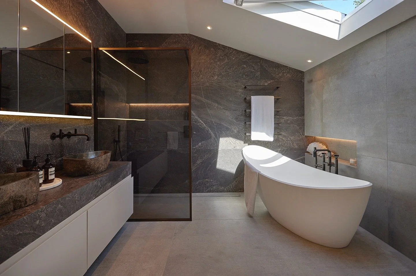 The Master Bathroom at Sycamore House ✨🖤 
A spa-like retreat with natural stone sinks, textured dark tiles, and elegant bronze brassware - indulgent, grounded, and beautifully layered.

For all enquiries please contact us on +44(0)1565 746788 or inf
