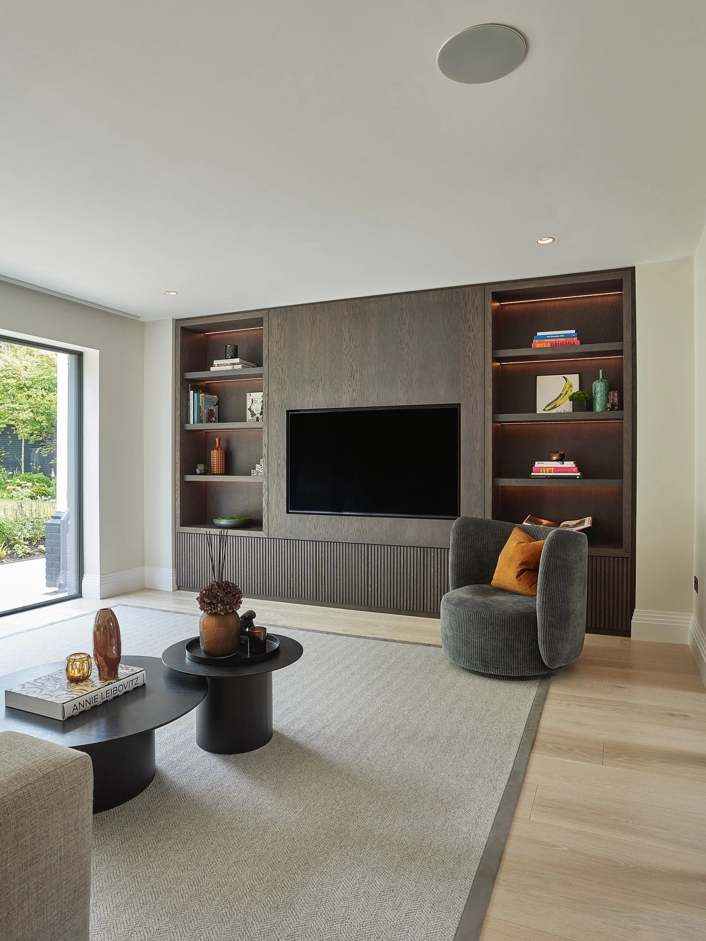 This contemporary family home is full of thoughtful detail, starting in the Day Living space.
A light, neutral base is layered with dark-stained oak cabinetry and reeded detailing, while pops of colour in the upholstery add personality - creating a s