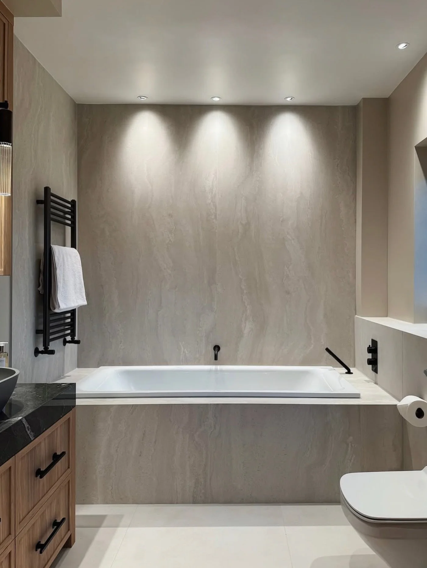 A look back at Apple Grove and the Guest En-suite transformation.

The brief called for a spa-like feel, achieved through soft, pale tones and large-format tiles with gentle travertine veining, offset by black brassware.

The stained oak feature vani