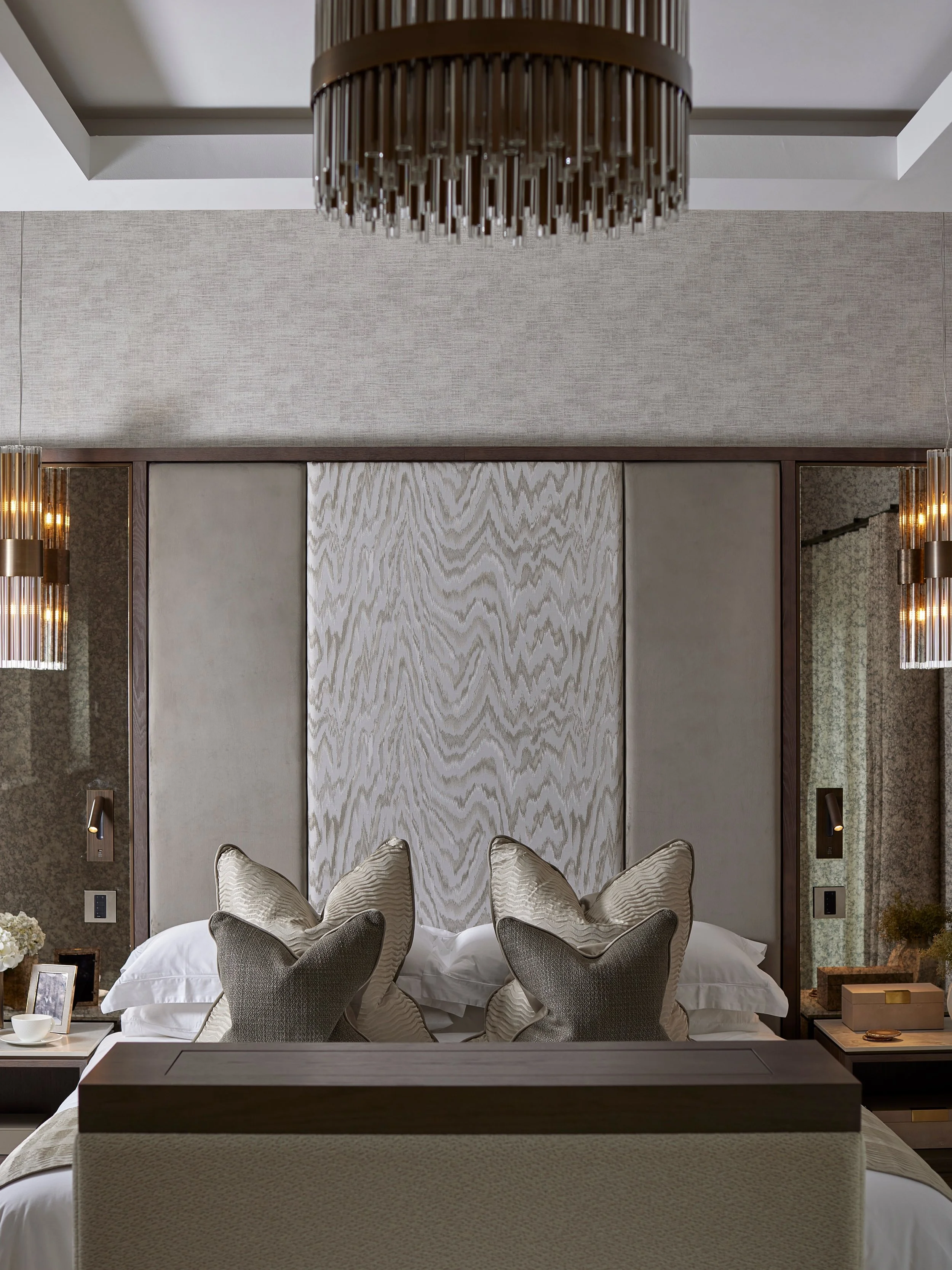 Hawthorn House - a complete Master Suite transformation.

An empty extension reimagined as a serene and layered retreat. The design centres around a bespoke panelled headboard, bringing together dark-stained oak, antique bronze detailing, mirrored pa