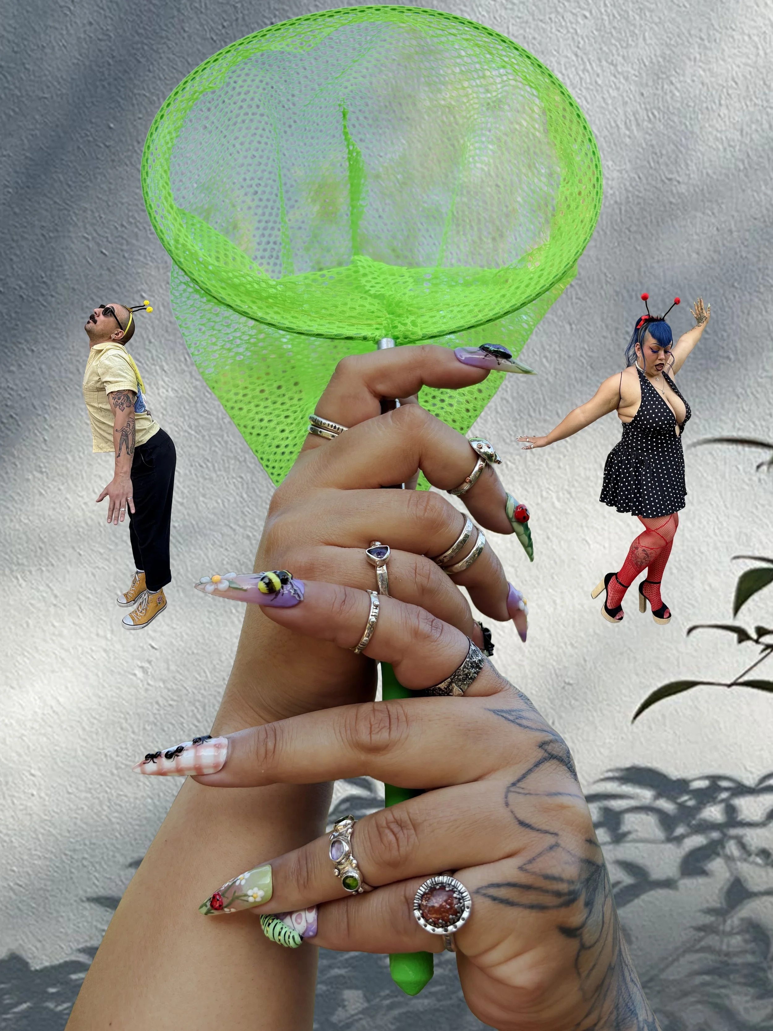 Two women wearing an assortment of silver jewelry, including necklaces, rings, and bracelets, with one woman wearing a white tank top and the other wearing a black zip-up hoodie.