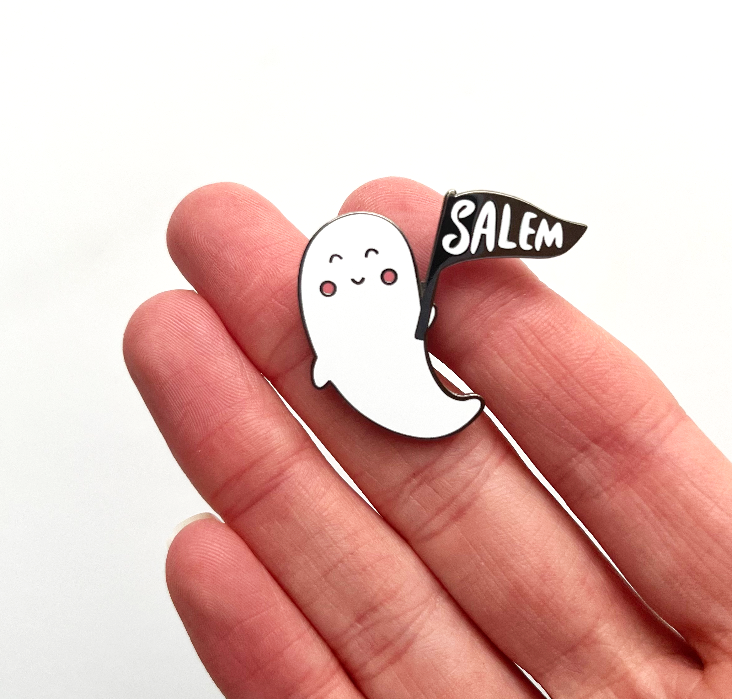 small salem ghost pin in hand