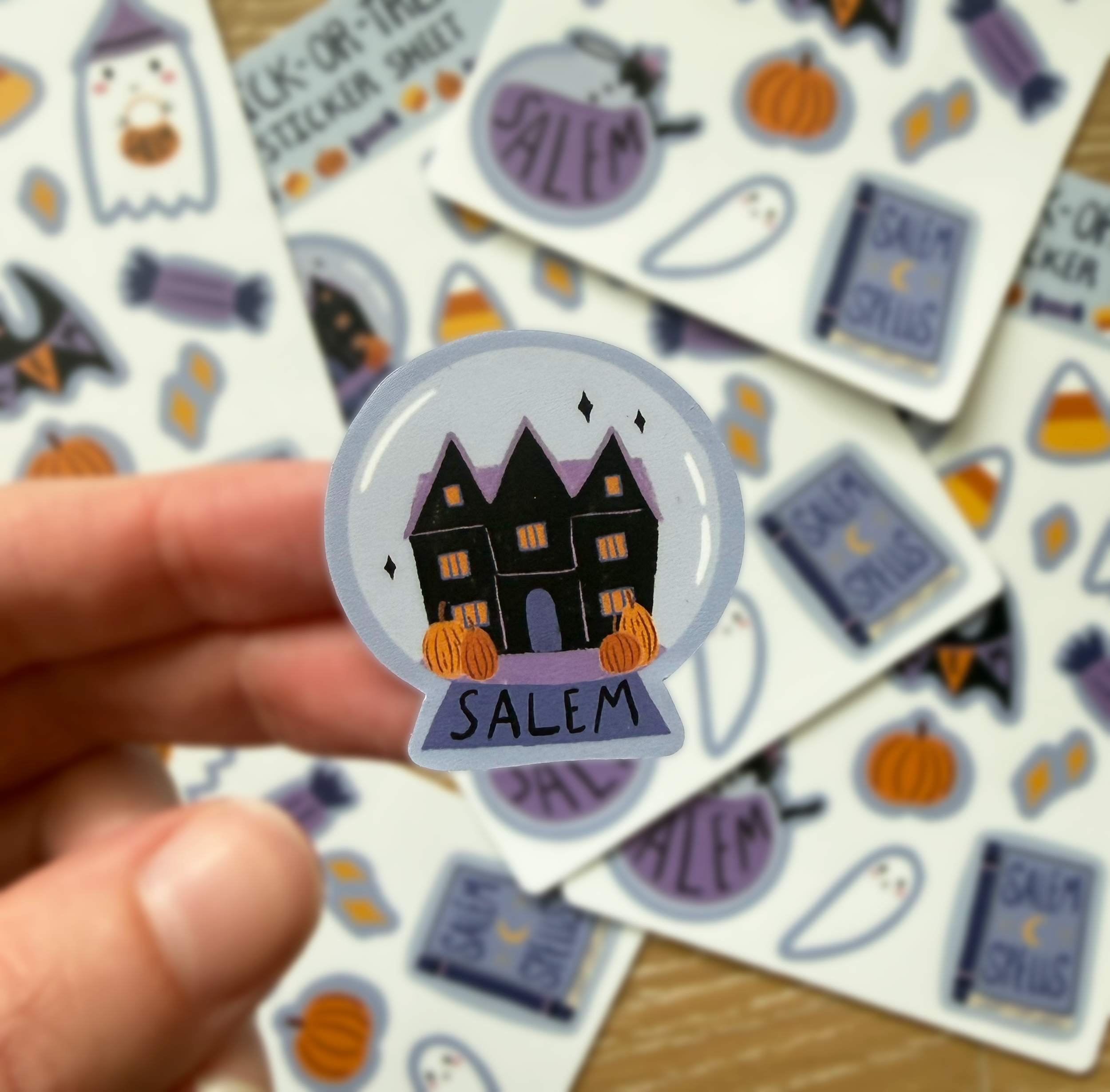 A closeup of the Salem Witch House building inside a globe.