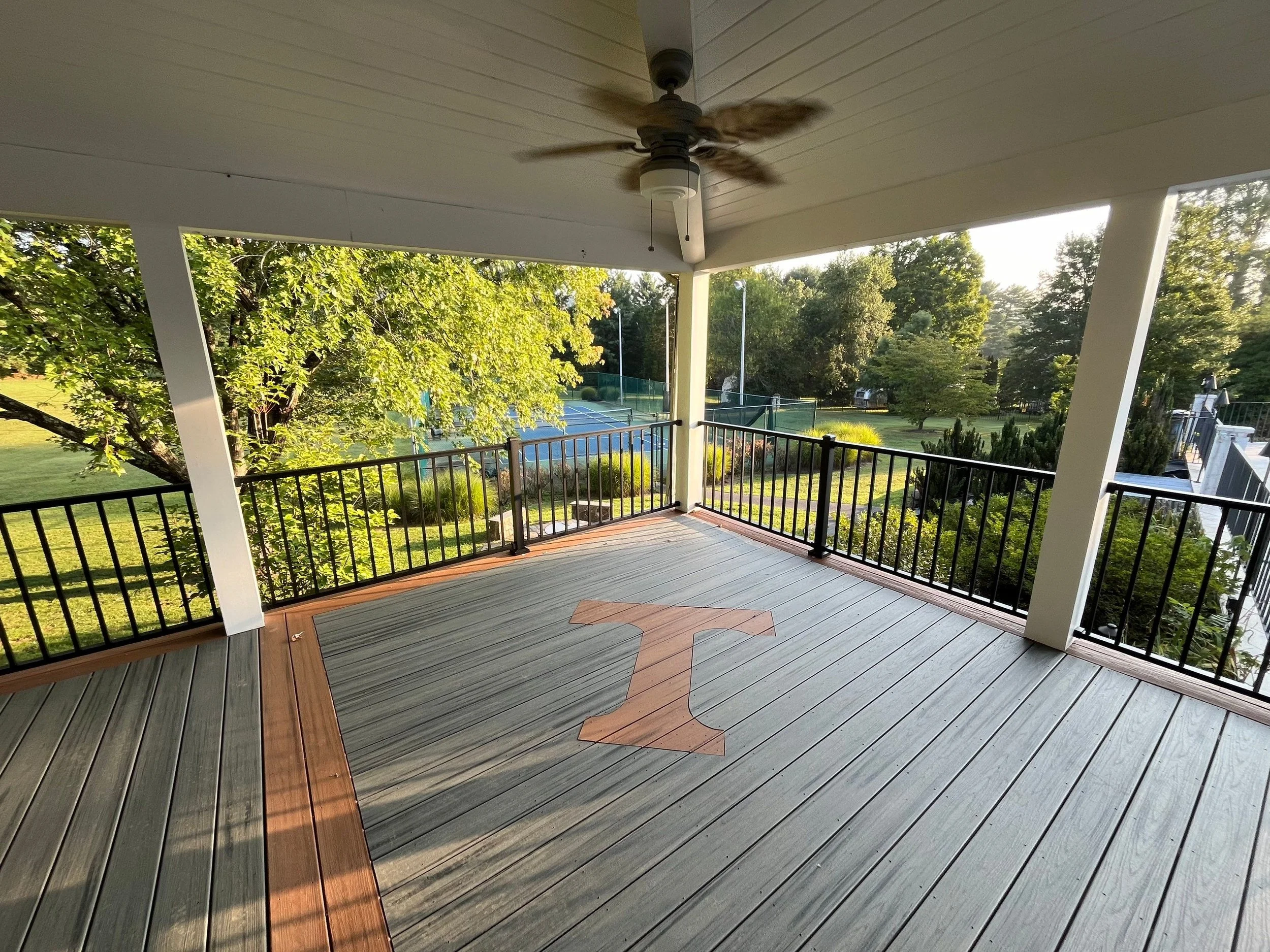 Custom Trex deck with bold orange "T" inlay, designed for a Tennessee fan. This low-maintenance composite deck blends clean lines with personalized detail, perfect for outdoor living in East Tennessee and Western North Carolina