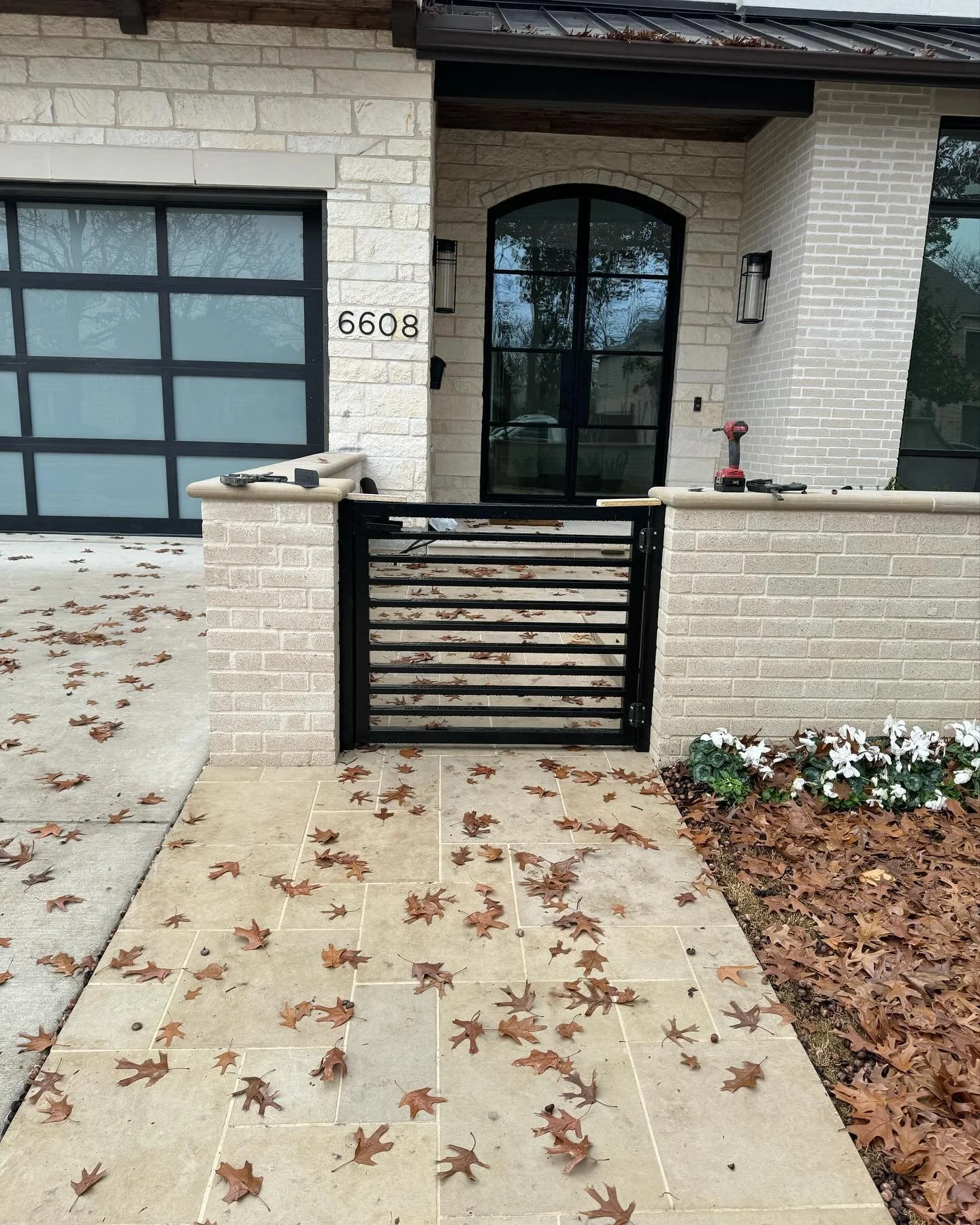 Modern slat entry gate with two backyard entry gates with frosted glass.
