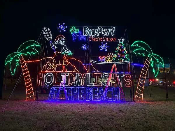 Custom Sponsorship Sign for holiday lights with a Santa figure, palm trees, snowflakes, a sailboat with a Christmas tree, and text reading 'Holiday Lights at the Beach' and 'BayPort Credit Union'.