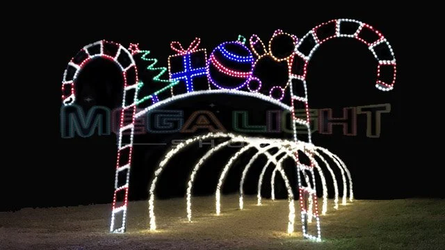 Mega Light Show custom commercial entry archway wireframe and drive thru tunnel featuring a large candy cane arch, colorful gift box, Christmas tree, and snowman.