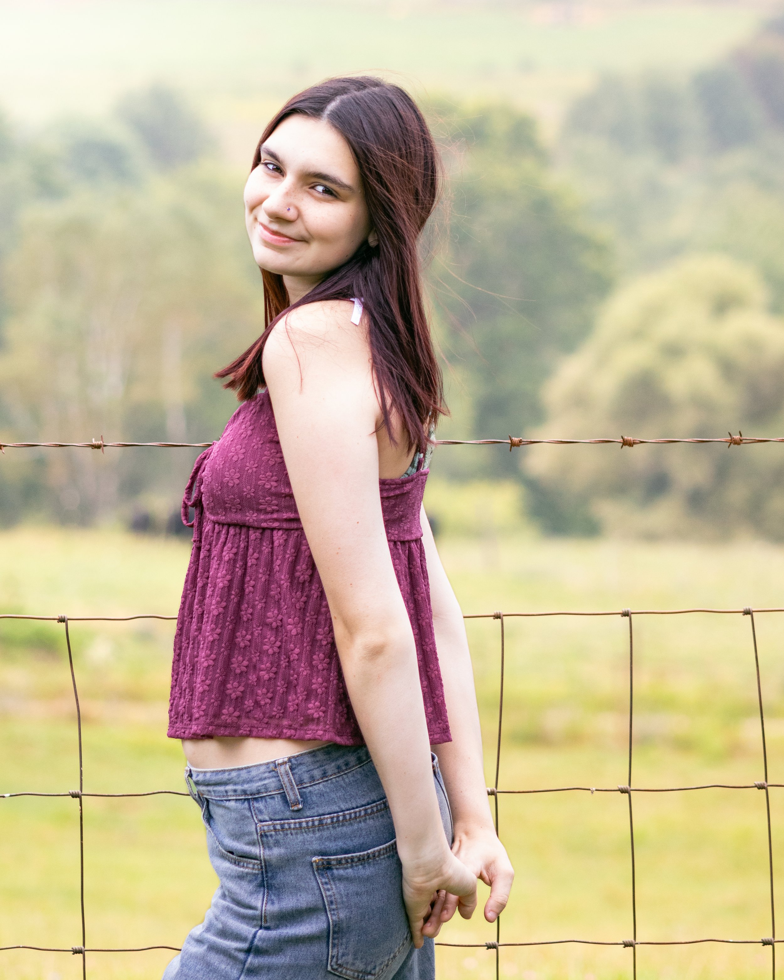 Girl in field smiling for a photo in Groton, Massachusetts. 