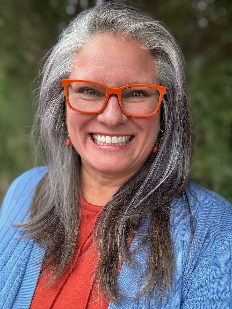 Smiling joyful professional organizer that specializes in mentoring people to organize their paper and live their legacy