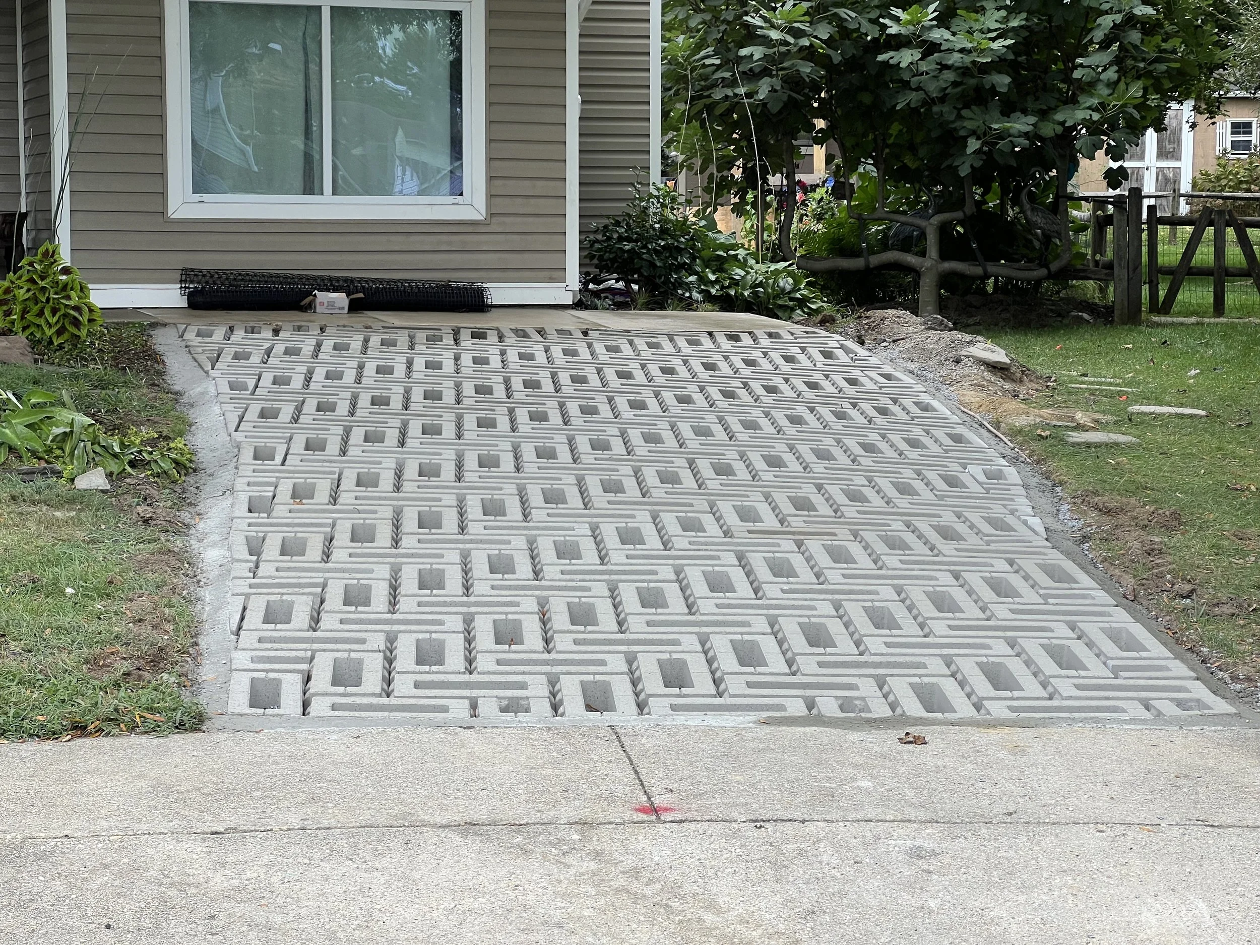 A beautiful job by Cape Landscape Contractors LLC https://capecontractorsco.com/ 
Now, it's time to fill and plant.  Some folks choose to fill with #8 crushed rock.  I chose to make a green driveway because.... well, plants!
