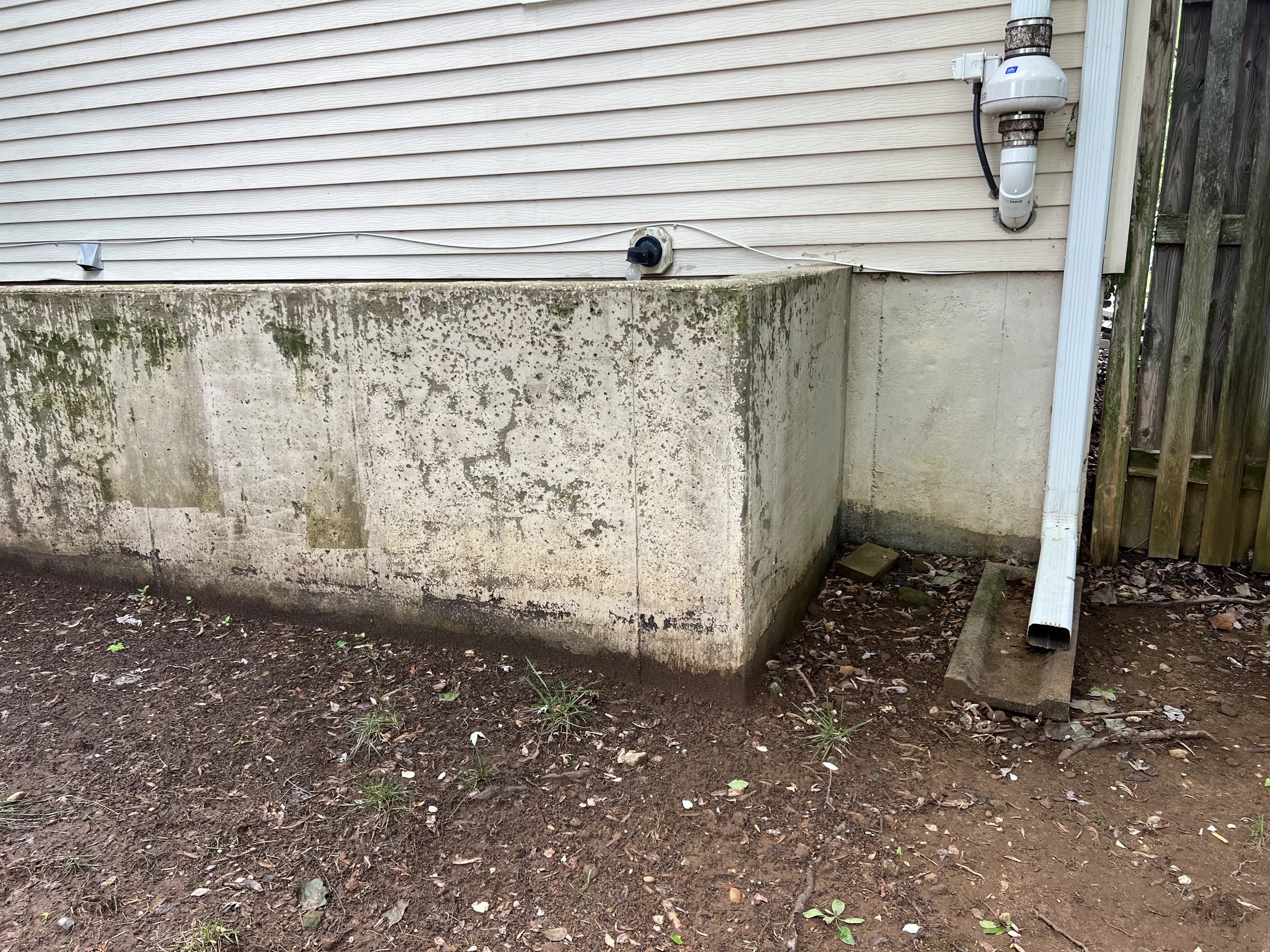 Exhibit C:  A downspout.  This downspout is one of four on the property.  One inch of rainfall will shoot around 150 gallons of water out of this downspout and onto the soil.