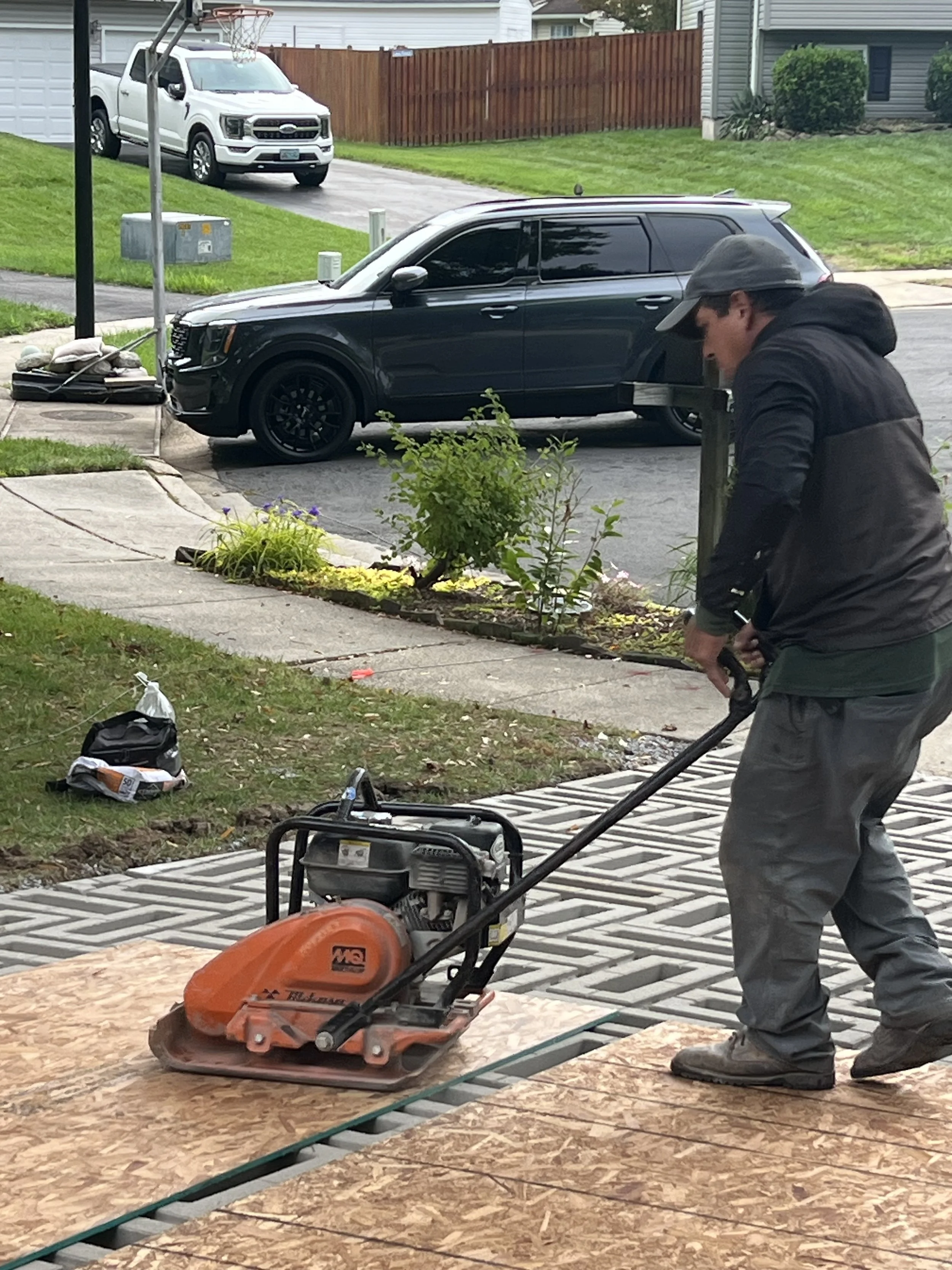 Compacting pavers into place.