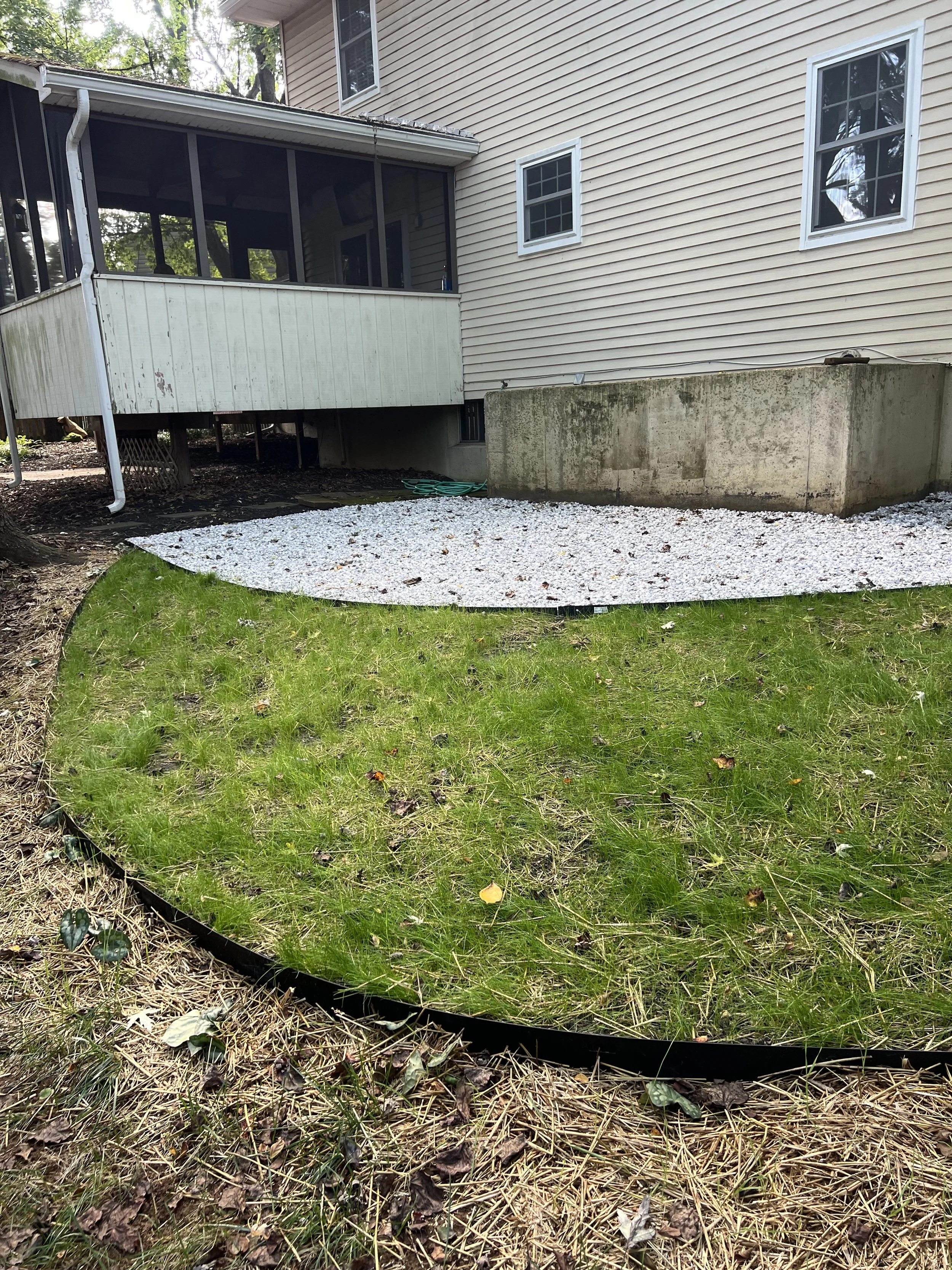 Based on the client's budget, we choose to install plantings at a later date.  But, look at the green lawn!  
An added bonus to slowing down water is that it has more time to naturally absorb into the ground.  Rain from impervious surfaces that is di