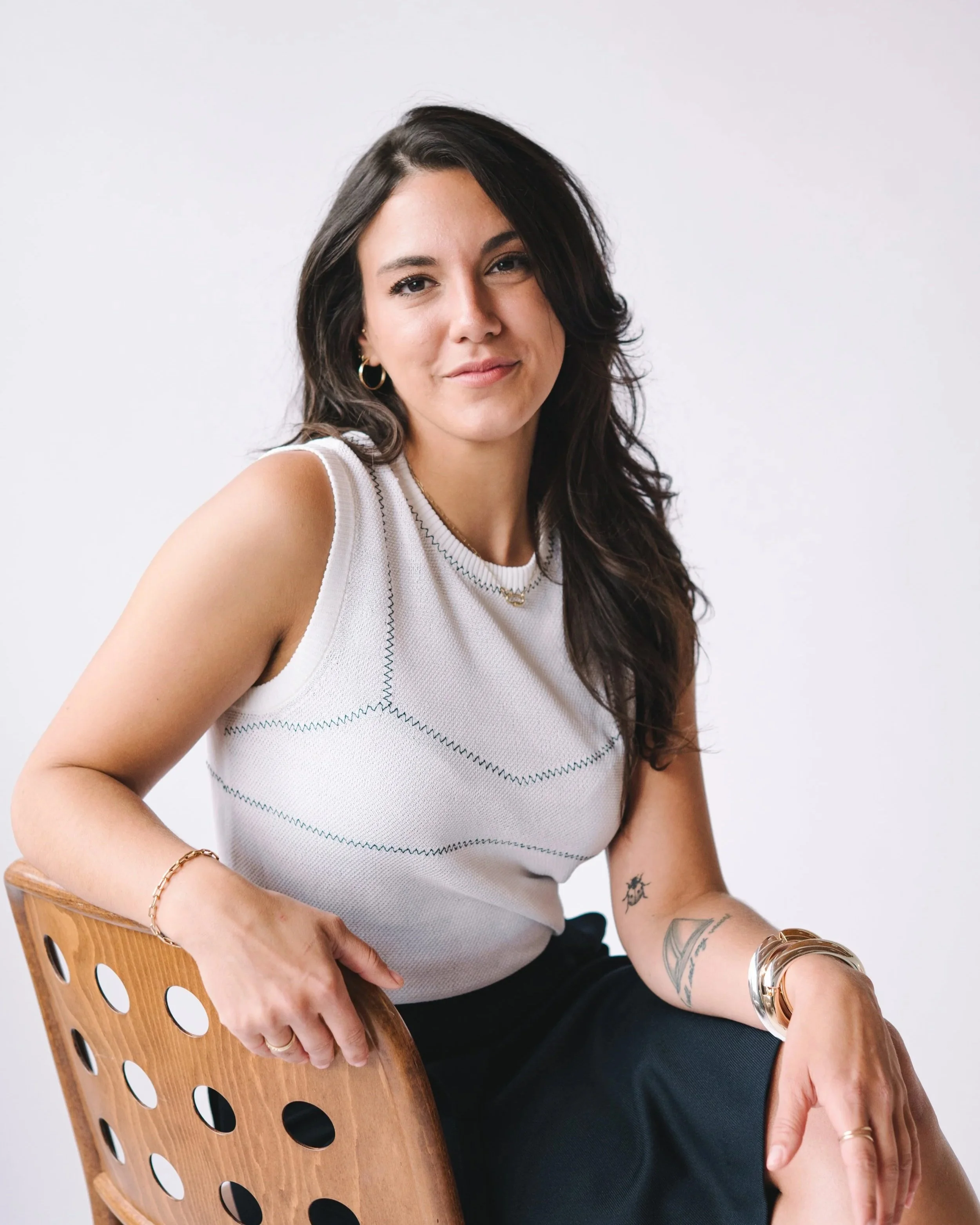 Brra founder seated with confident, relaxed posture—embodying the intelligence, style, and strength behind Brra’s mission to redefine women’s comfort through smart, wearable innovation.
