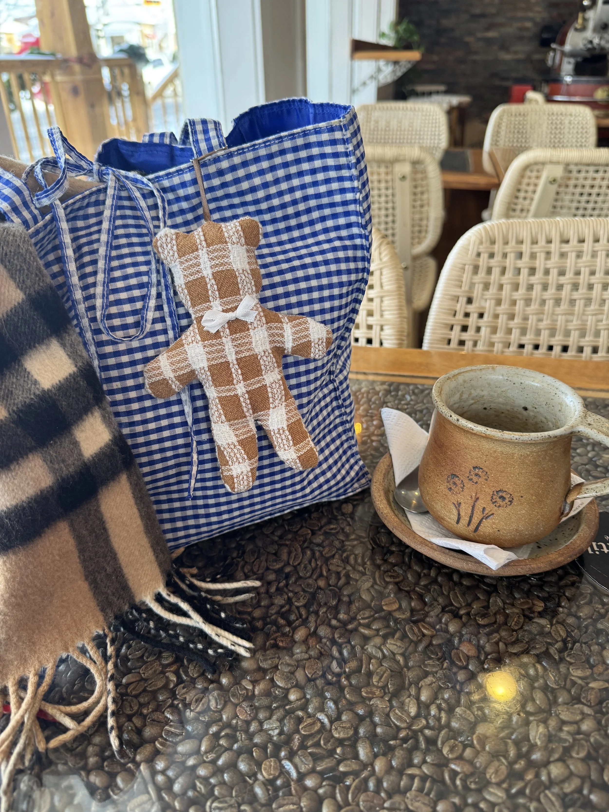 Willow Branch Bear purse charm at a coffee shop on a blue gingham purse