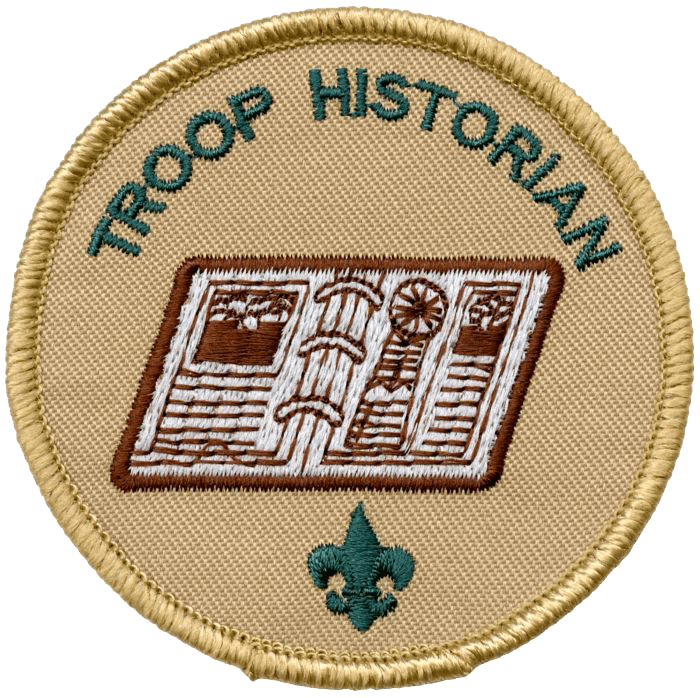 A round embroidered patch with a yellow border, featuring the words 'TROOP HISTORIAN' at the top, a depiction of an open book with columns and a wheel at the center, and a small fleur-de-lis symbol at the bottom.
