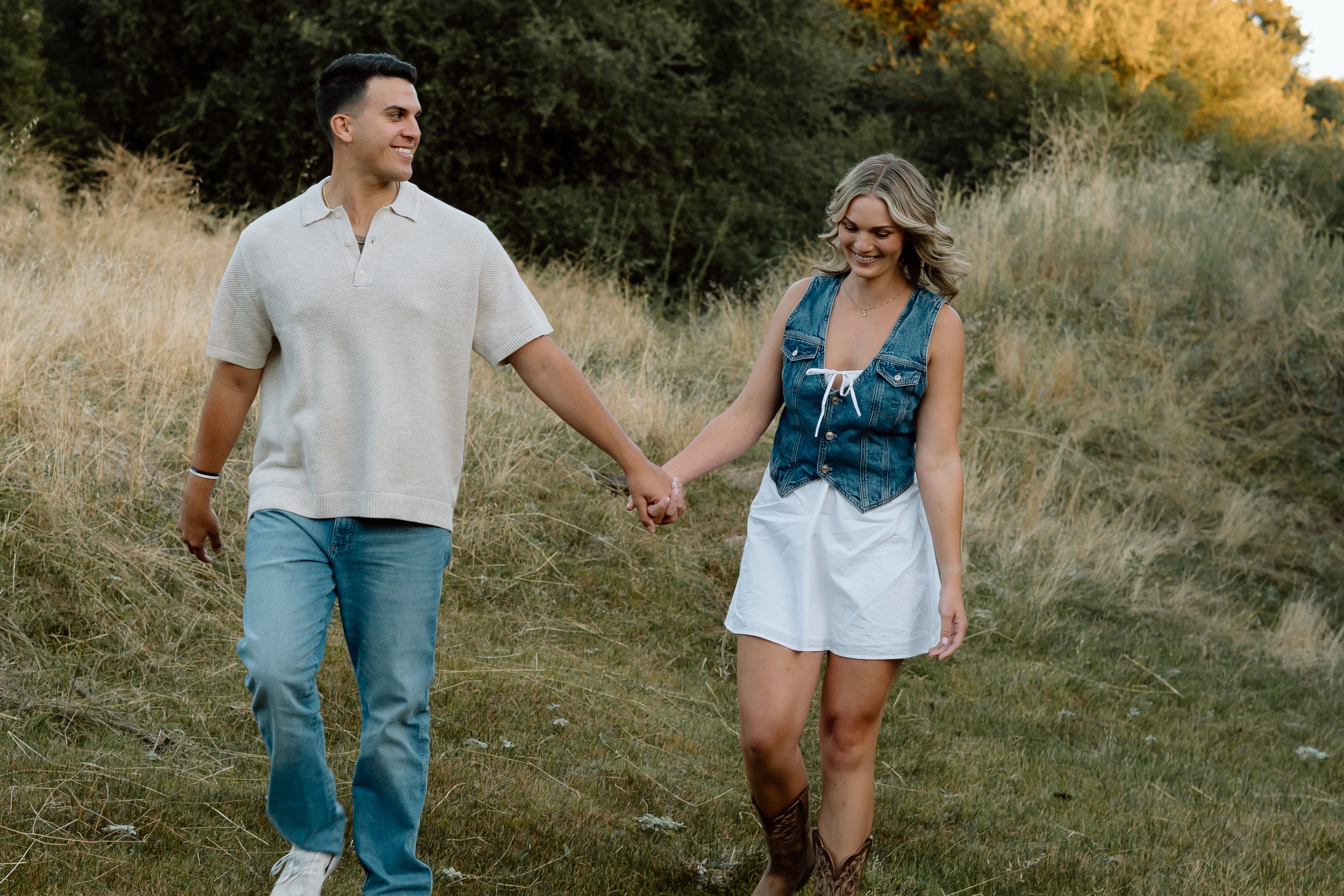 couple-walking-in-field-holding-hands.jpg