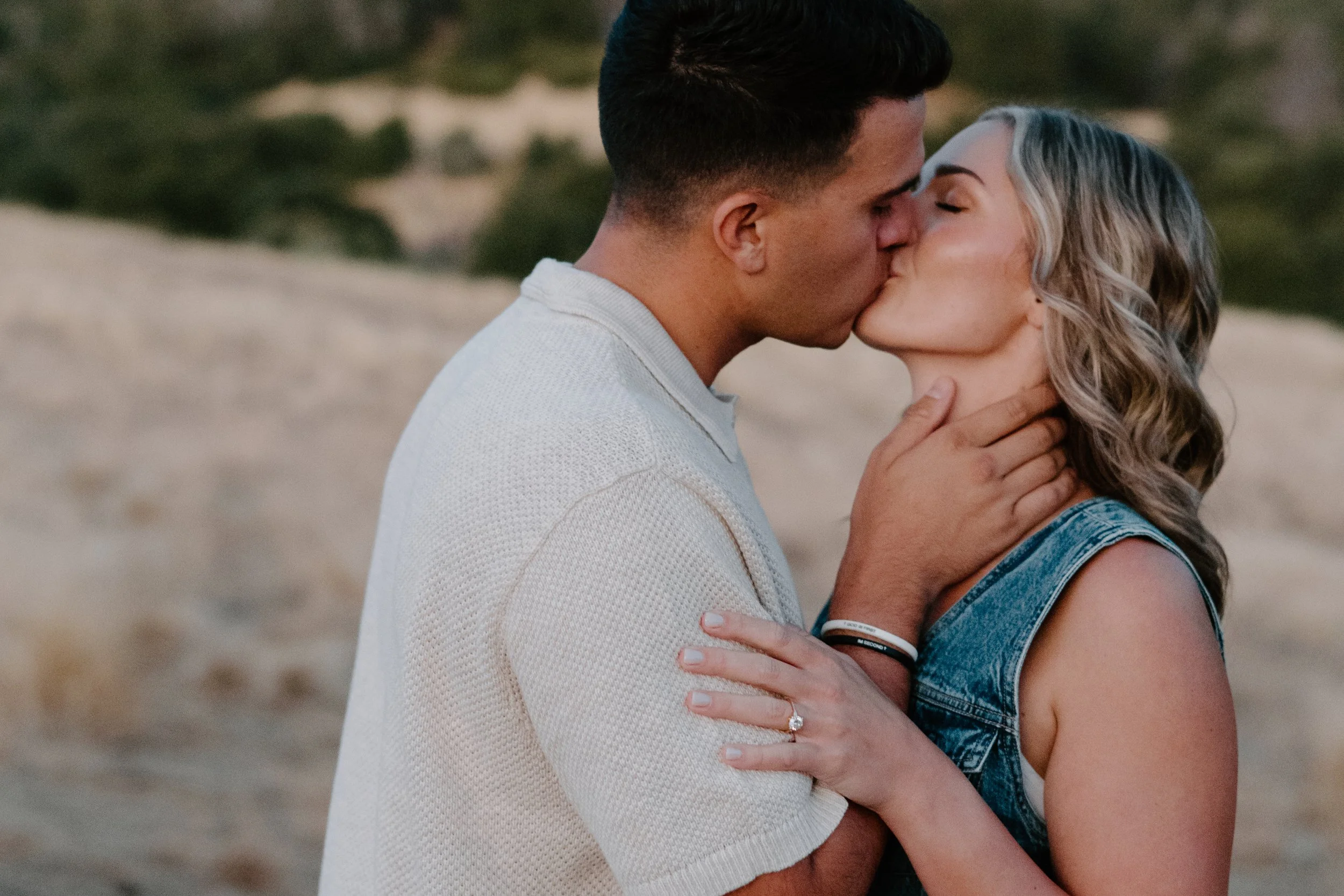engaged-couple-kissing-in-mountains.jpg