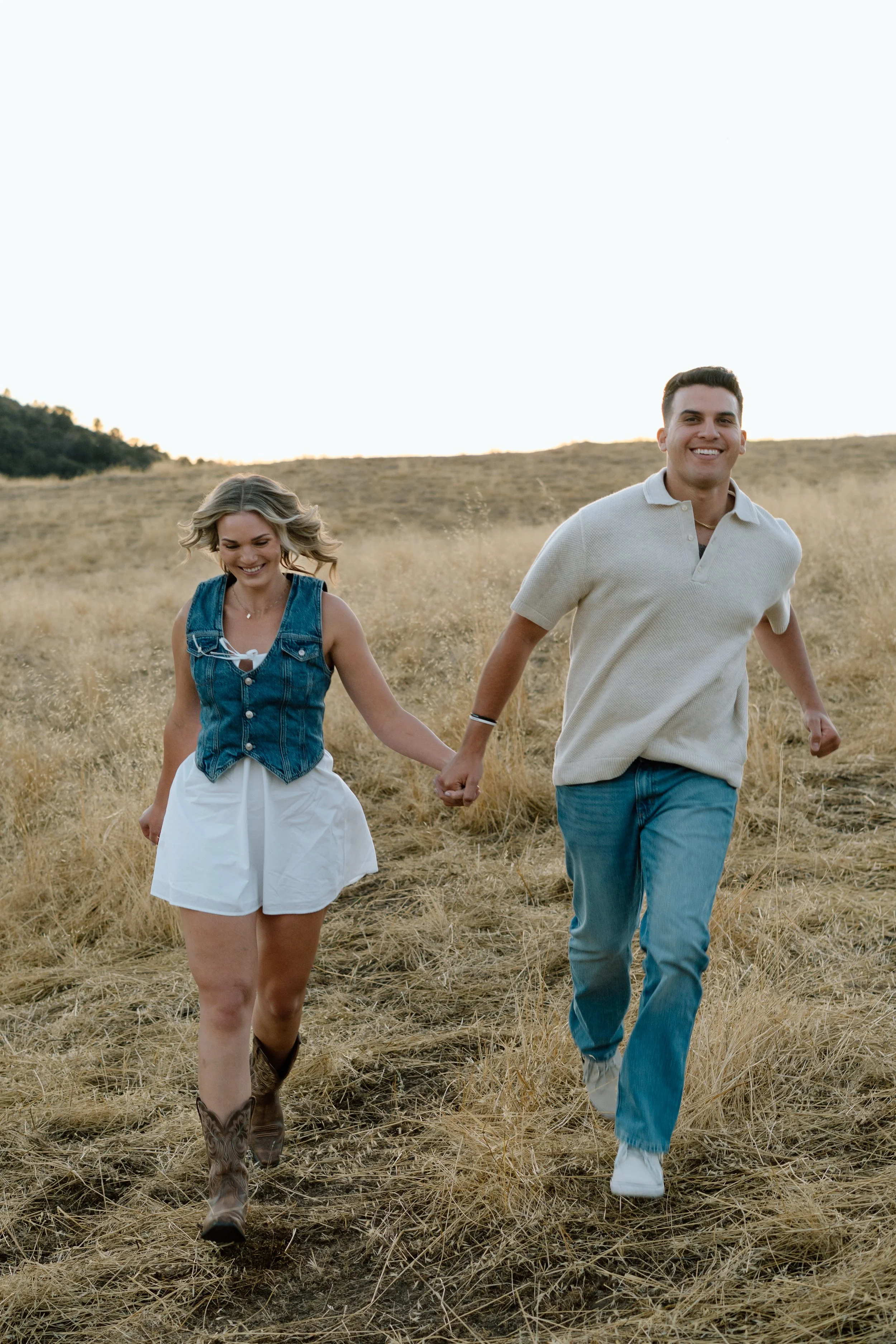 engaged-couple-smiling-and-running-together.jpg