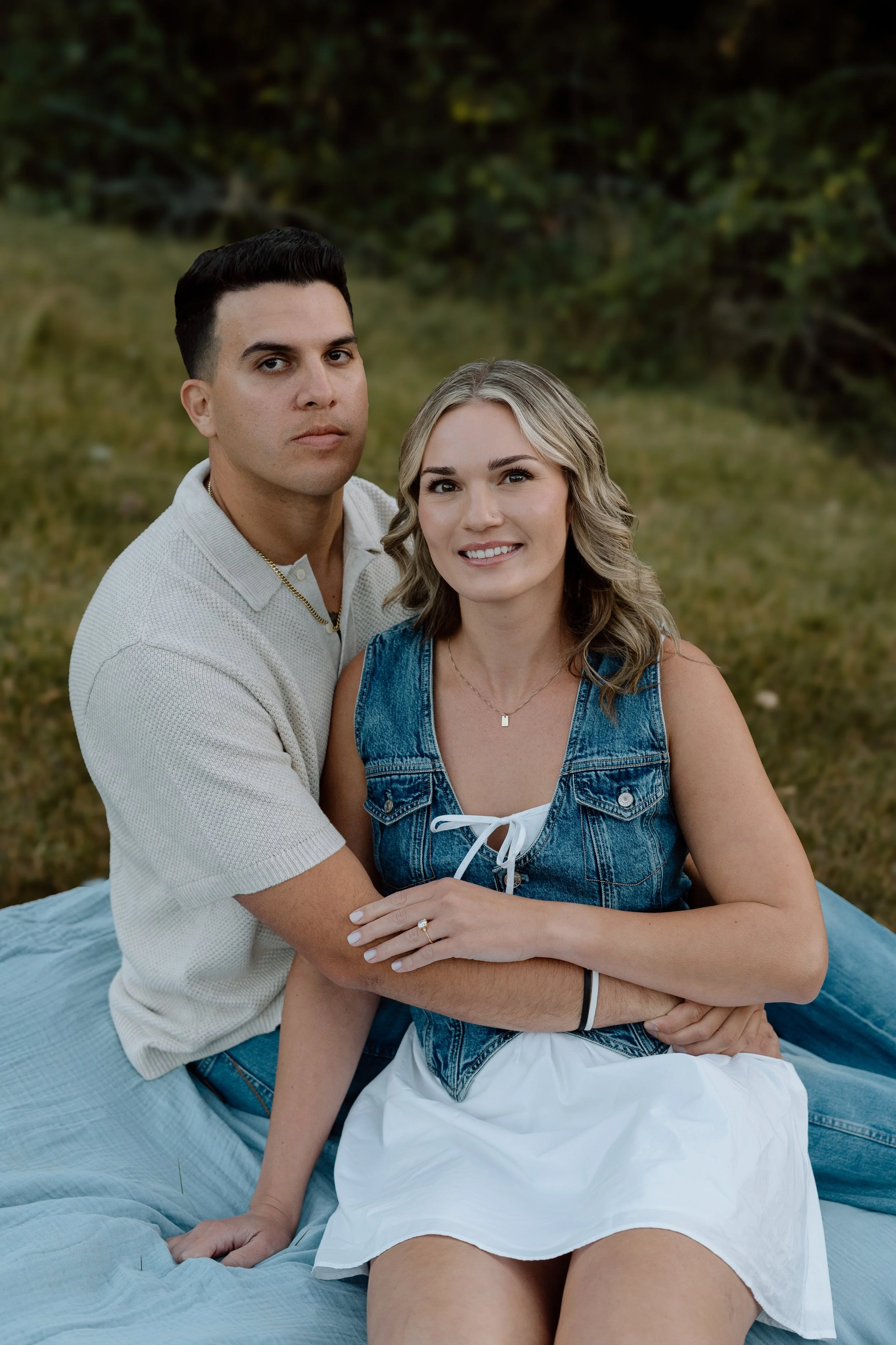 engagement-photo-couple-sitting-in-field.jpg