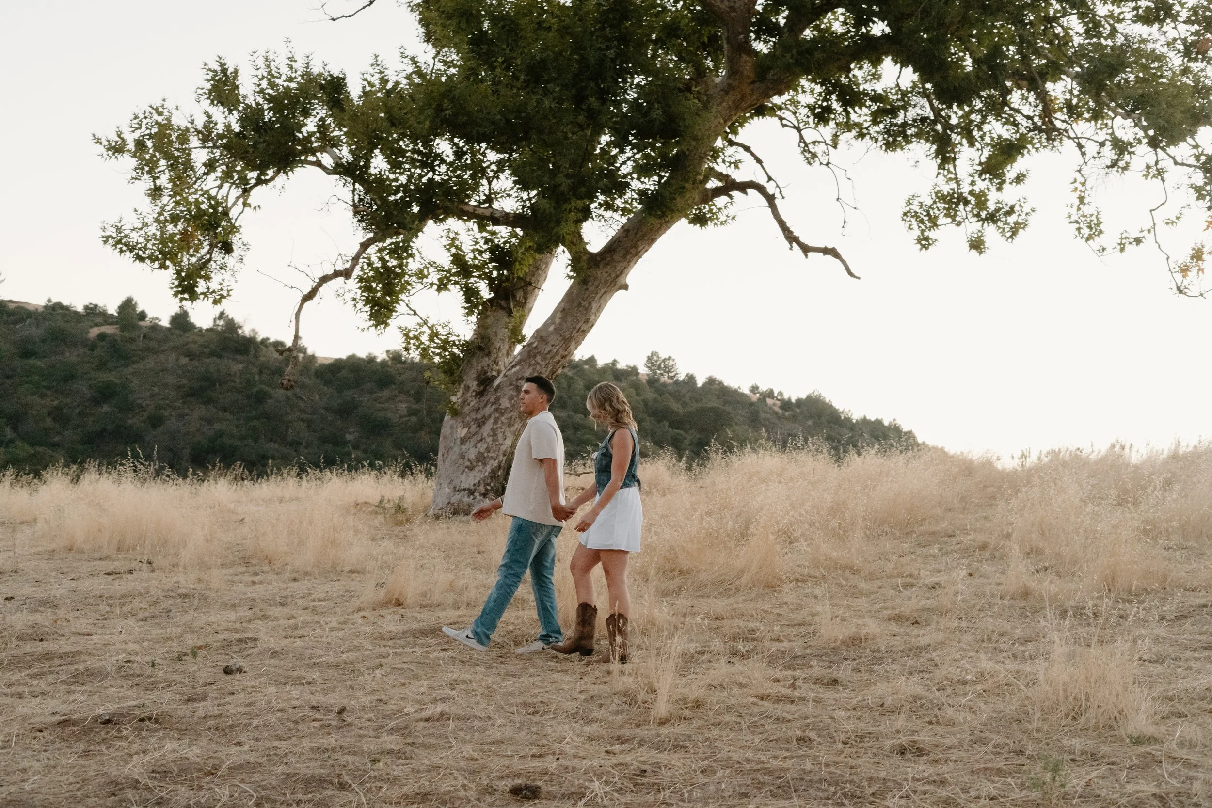 engagement-photo-couple-walking-under-tree.jpg