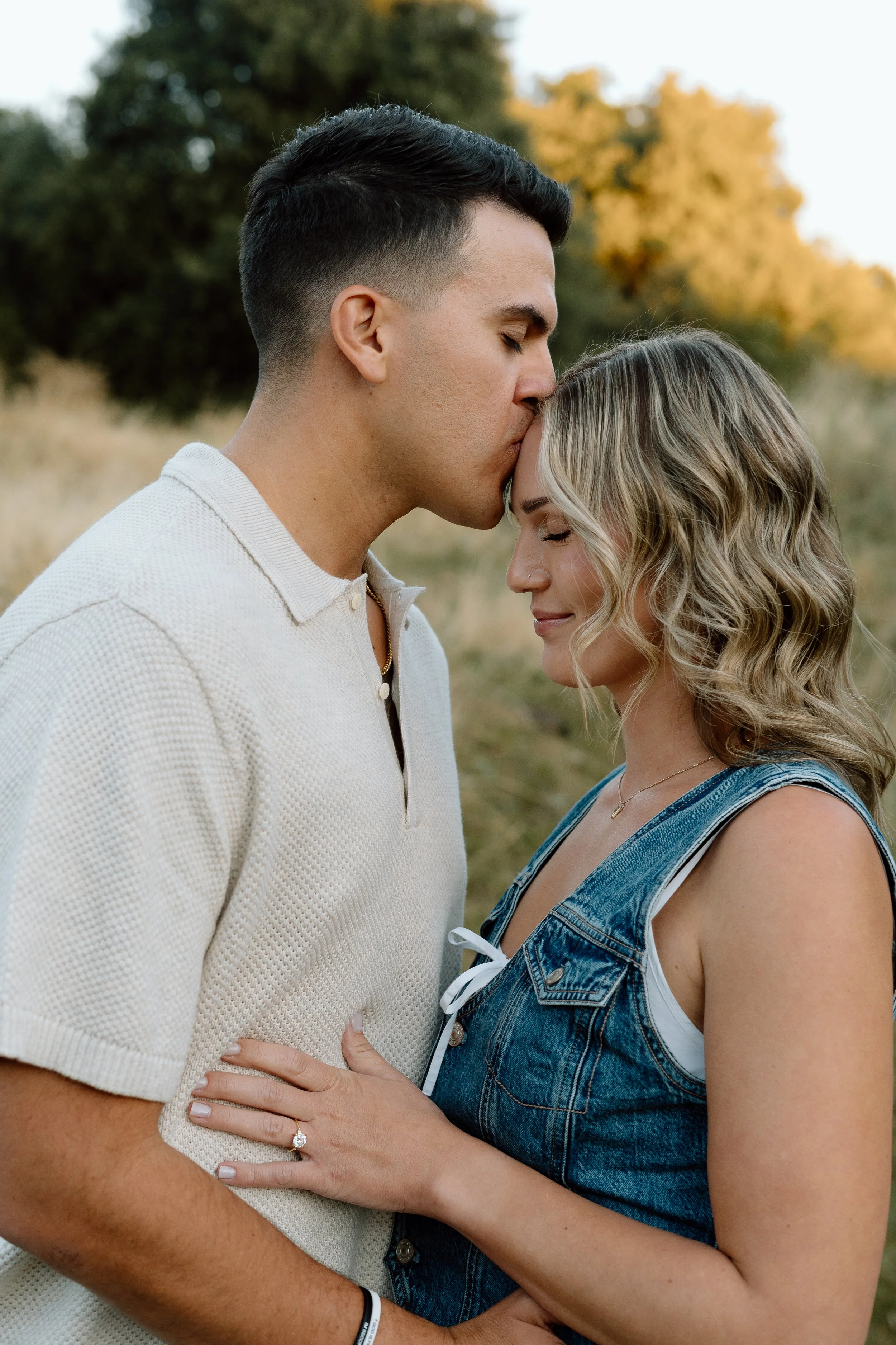 man-kissing-fiance-forehead-julian-california.jpg