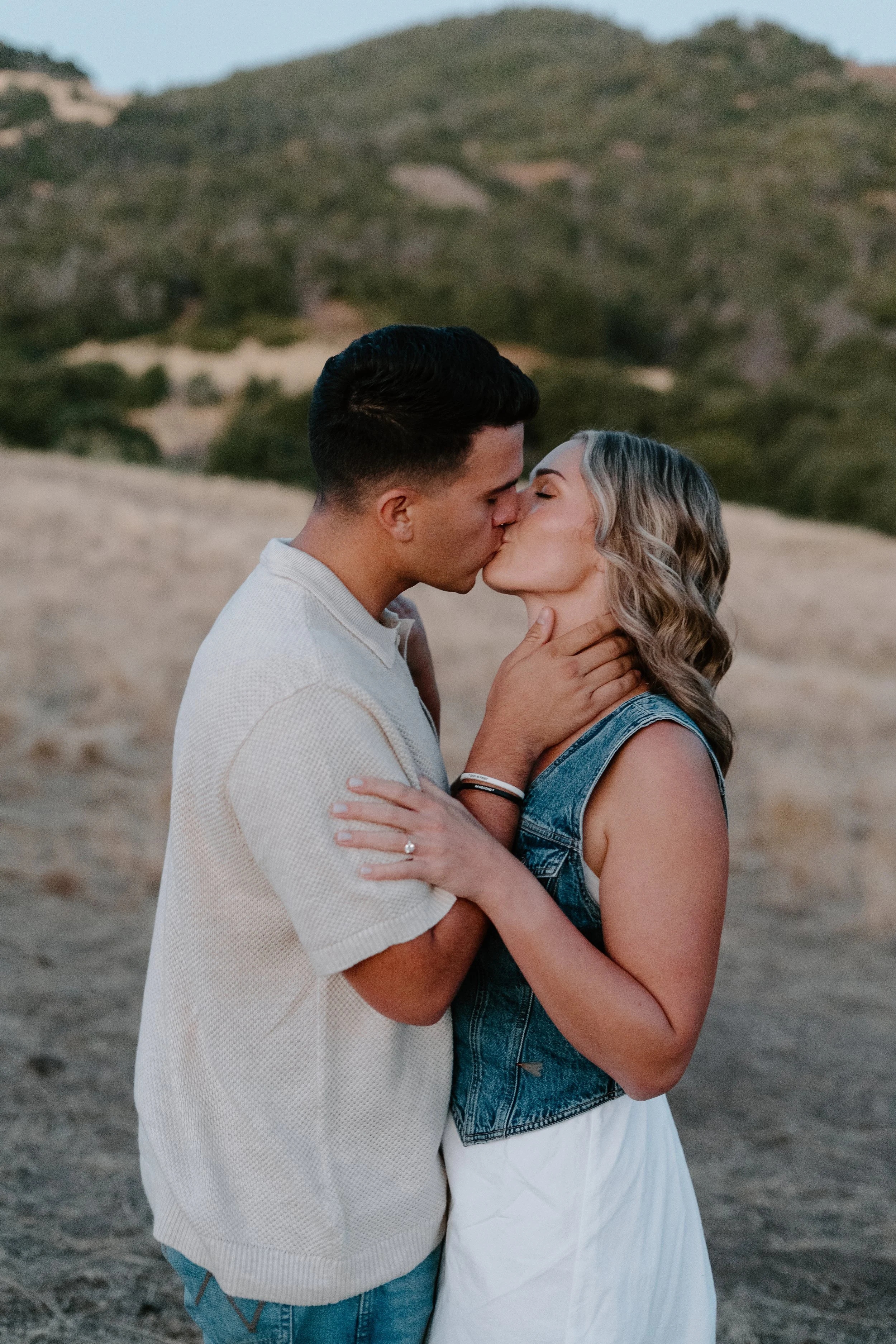 newly-engaged-couple-kissing-in-the-mountains-of-julian-california.jpg