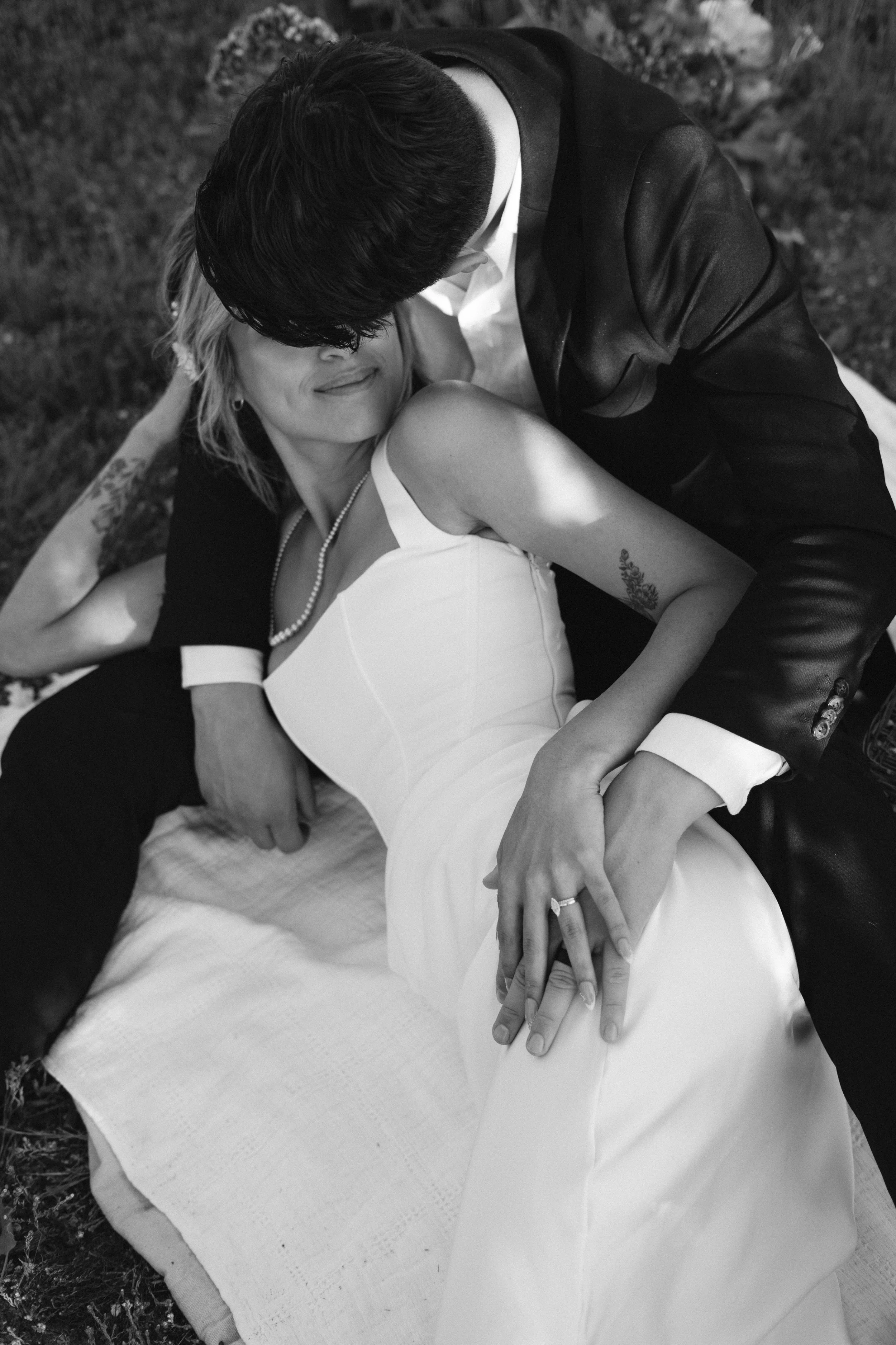 couple-cuddling-in-grass.jpg
