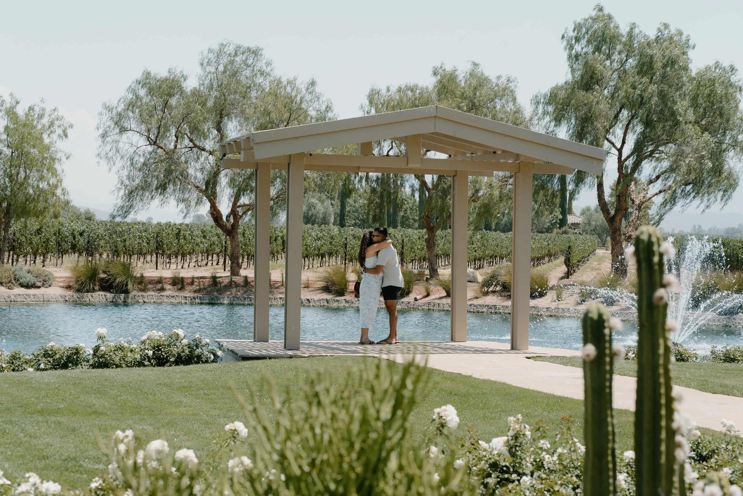 proposal-couple-hugging-under-gazebo .jpg