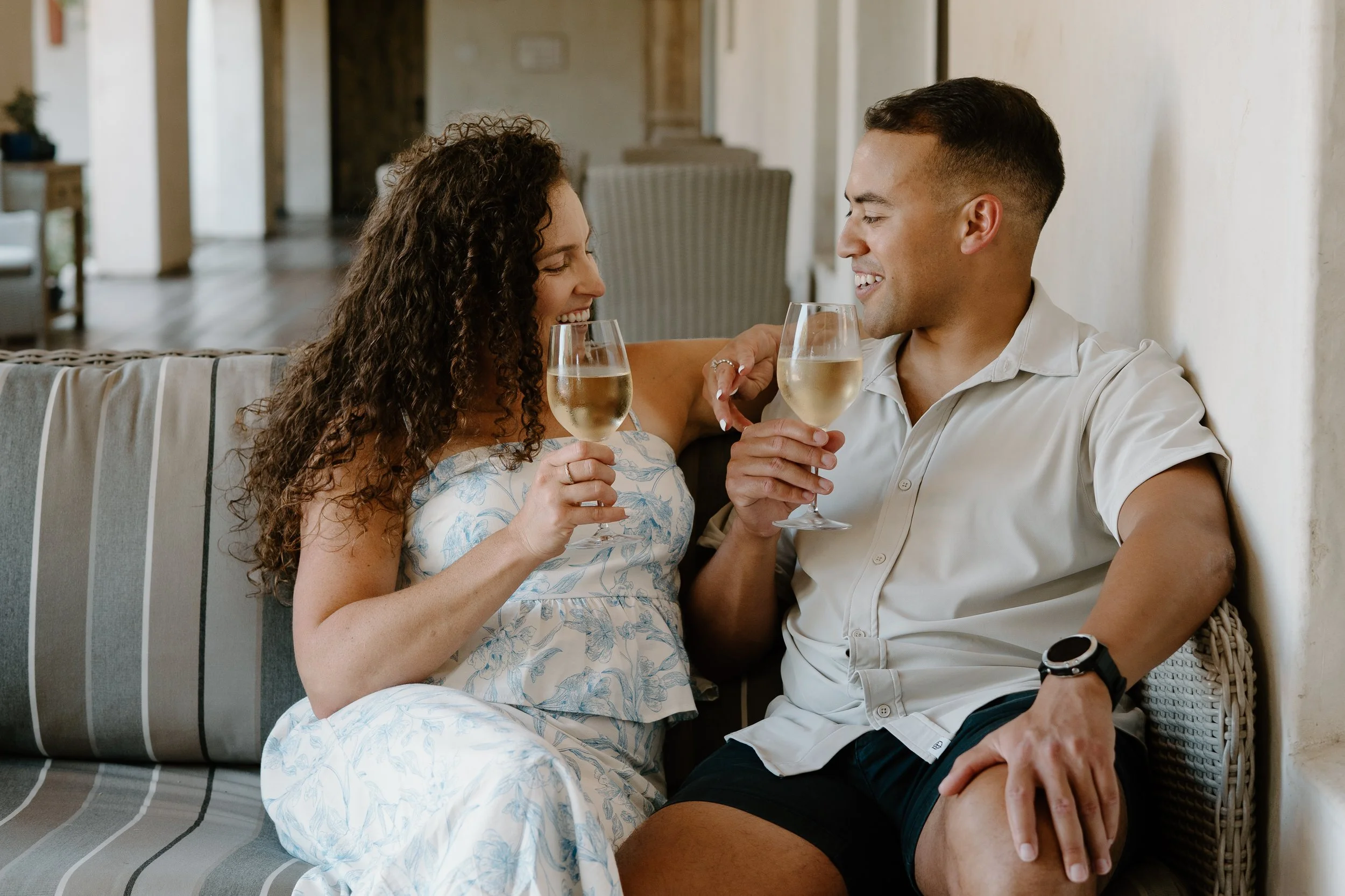 engaged-couple-celebrating-with-glass-of-wine.jpg