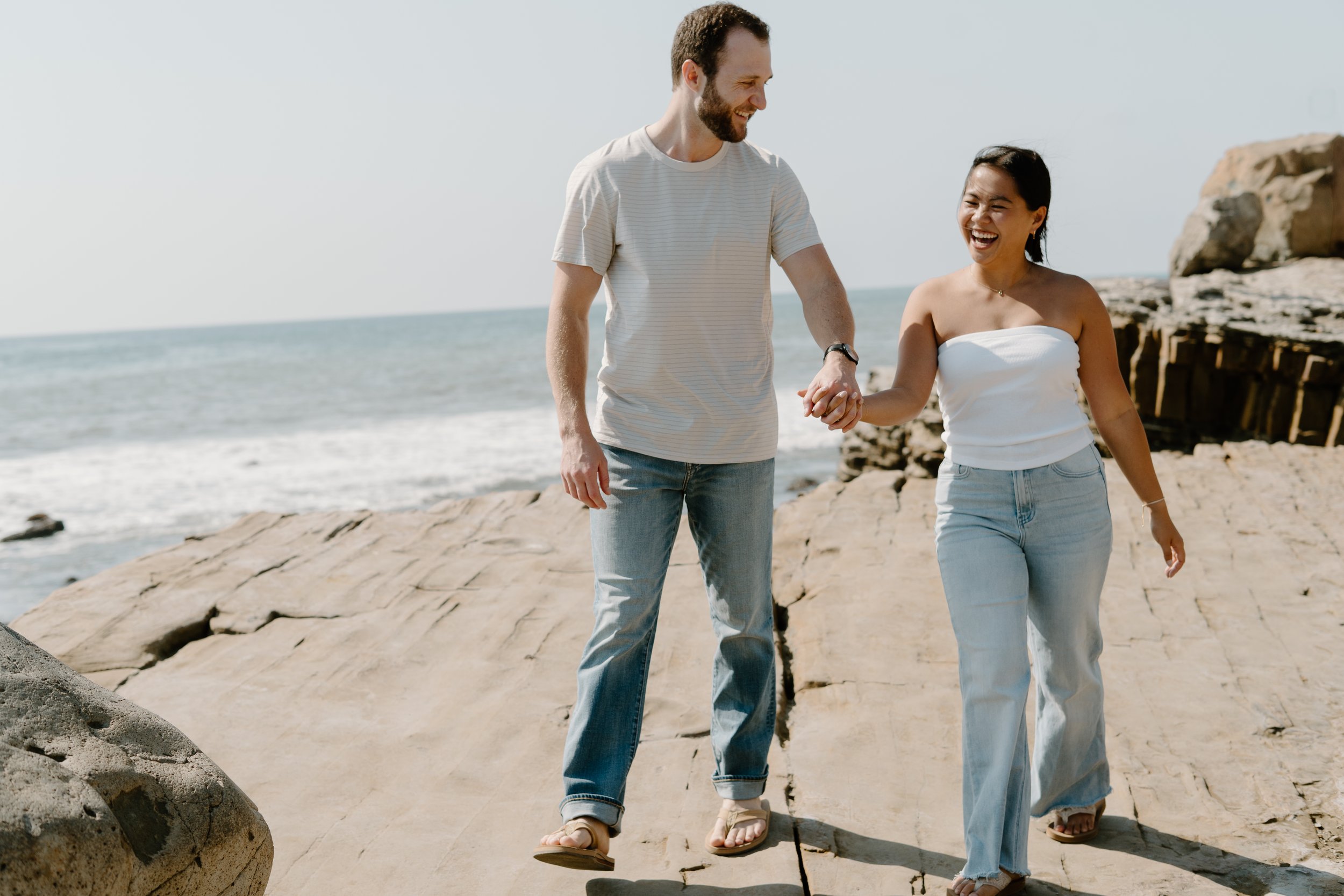 couple-holding-hands-walking-cliff-side.jpg