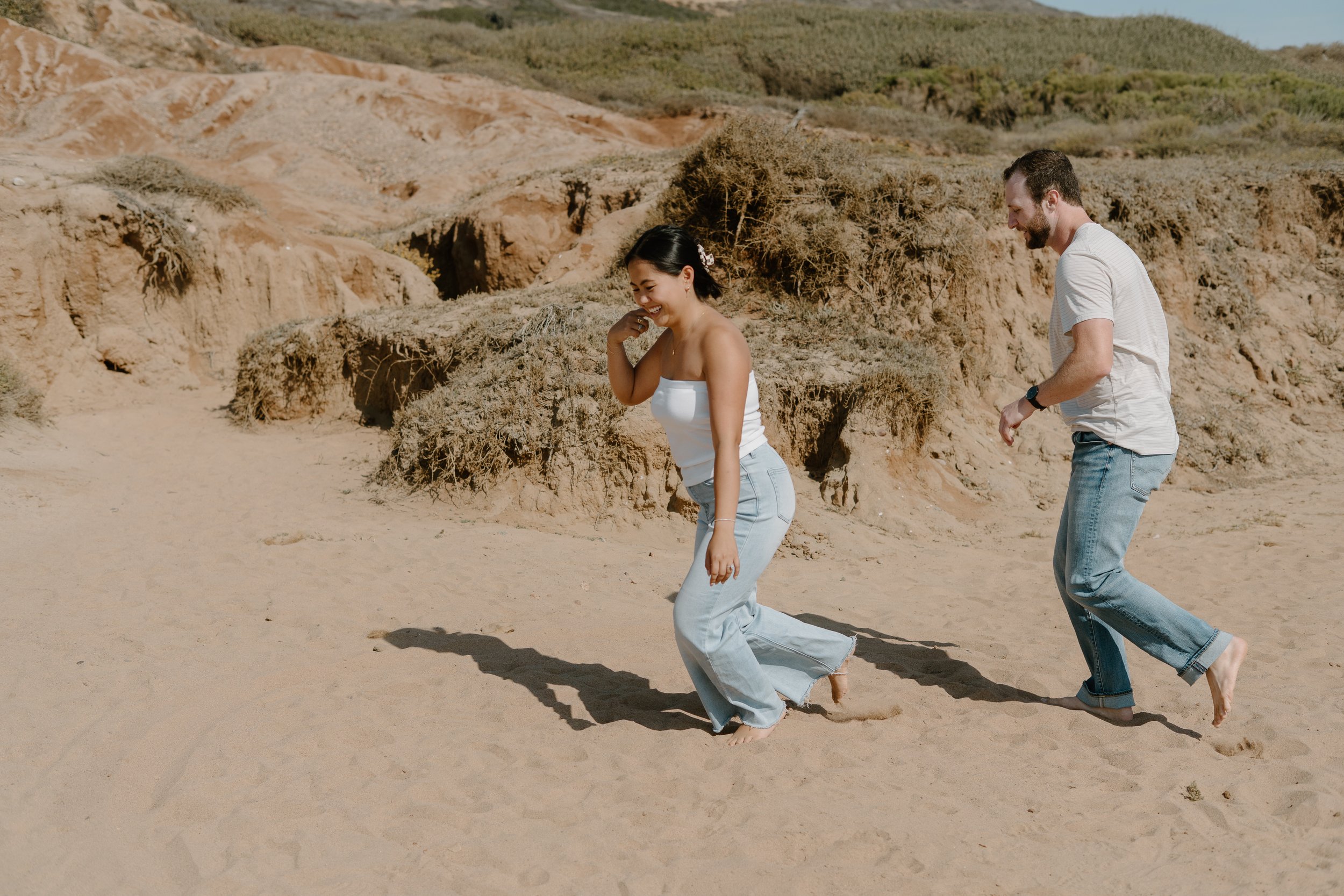 couple-playing-tag-la-jolla-beach.jpg